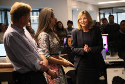 Nancy Barnes, right, meets the newsroom of the Boston Globe after she was named as the incoming editor of paper in 2022. She addressed the newsroom with Brian McGrory, left, and CEO Linda Henry, center. (Suzanne Kreiter/The Boston Globe via Getty Images)
