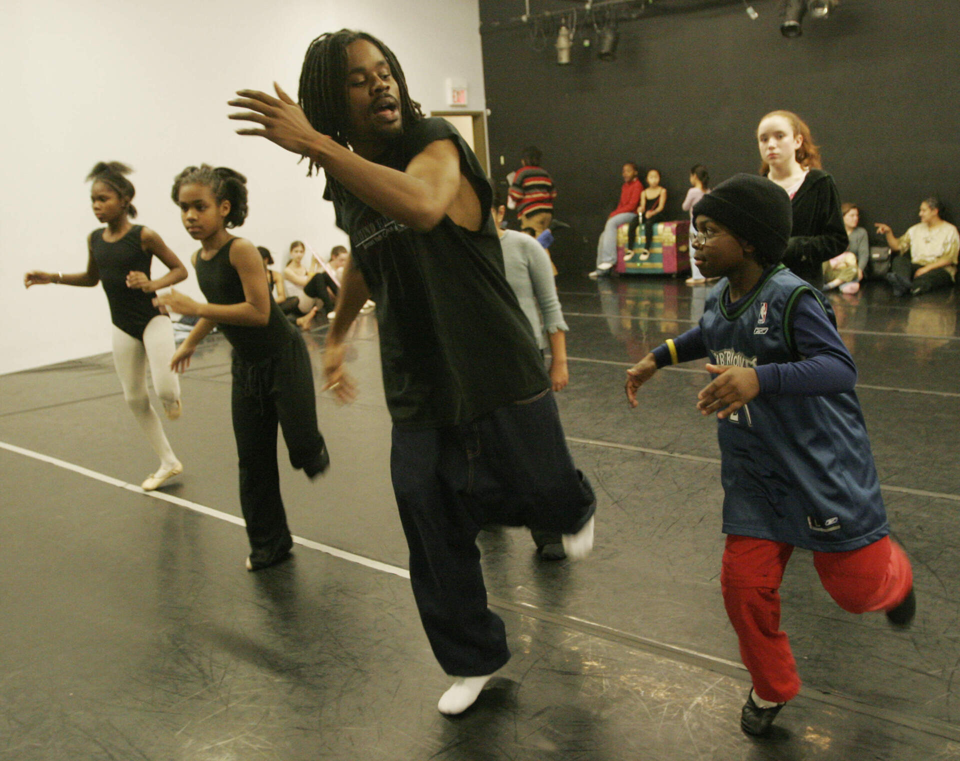 Khalid Hill, center, runs through a tap number with Jack Humsey, right, during a rehearsal of "Urban Nutcracker" in 2004. (David Kamerman/The Boston Globe via Getty Images)