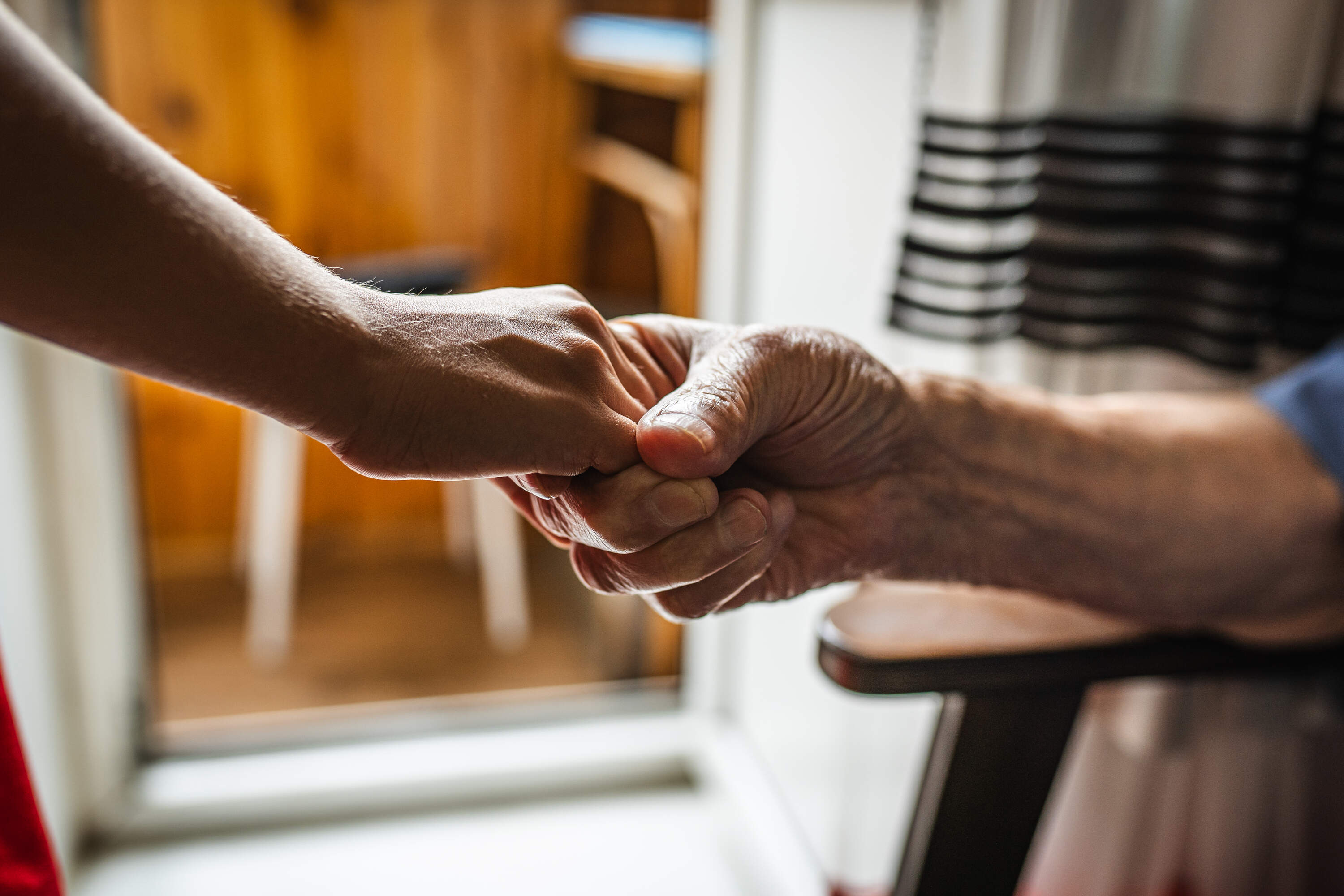 Two people hold hands. (Olga Rolenko/AP)