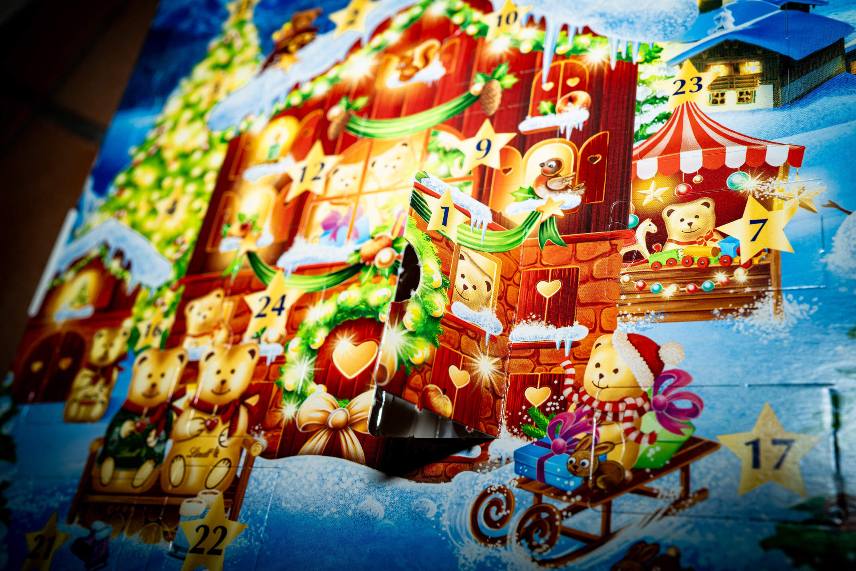 A person opens the first box of their advent calendar and takes out a Lindt chocolate bear. (Amaury Cornu/AFP via Getty Images)