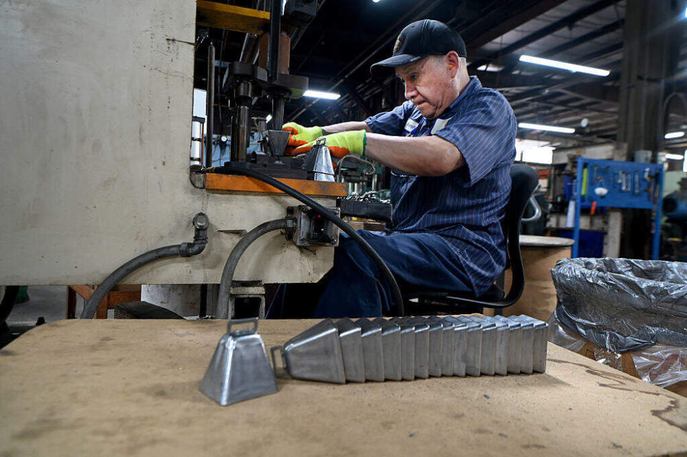 Employee Bonifacio Zegarra works attaching loops to cow bells at the Bevin Brothers Manufacturing Company. (Jim Michaud/Connecticut Post via Getty Images)