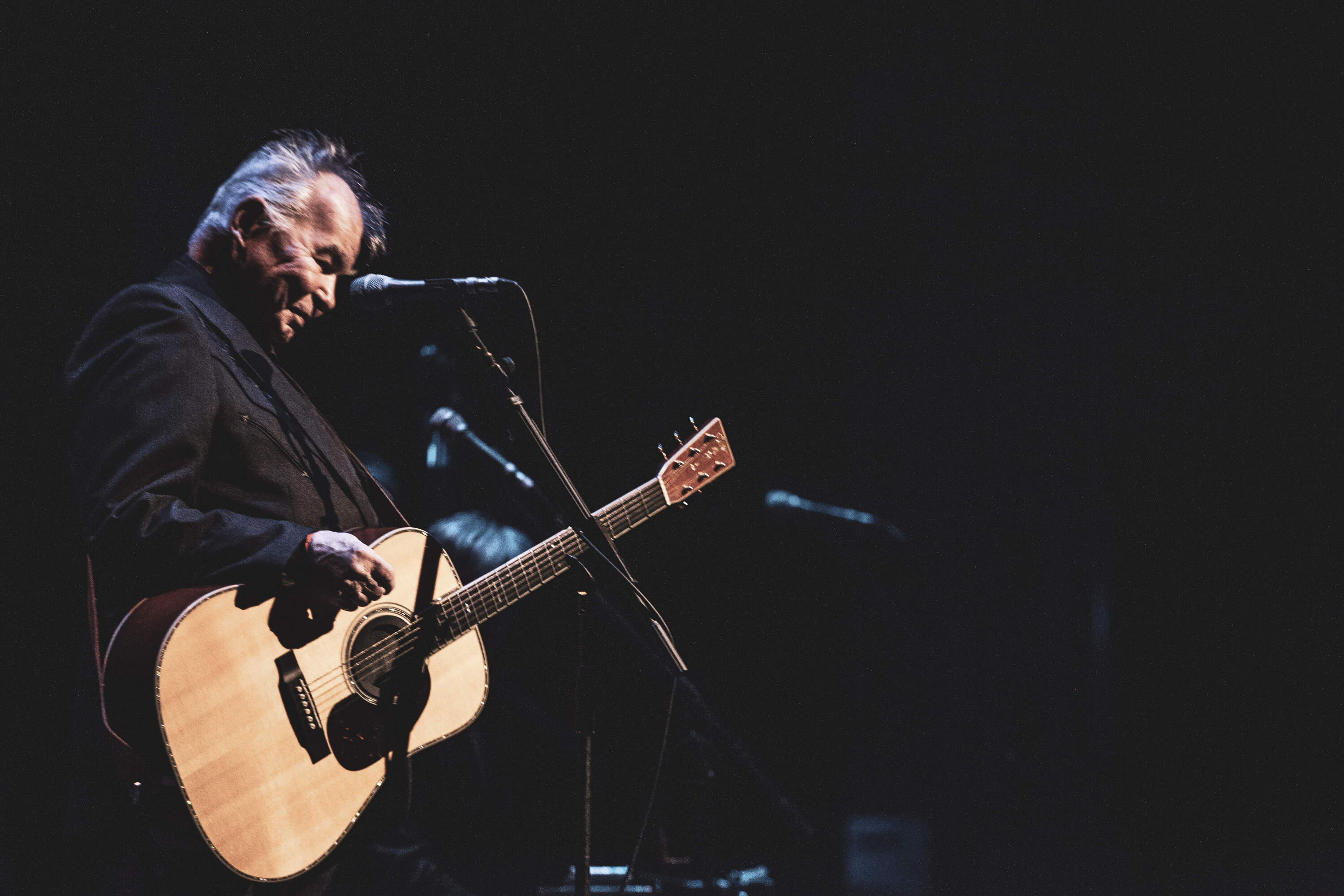 John Prine plays guitar. (Courtesy of Abramorama, Oh Boy Pictures and Radicalmedia)