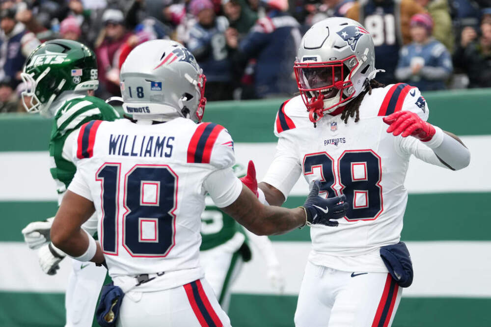 New England Patriots running back Rhamondre Stevenson (38) celebrates a touchdown against the New York Jets with teammate Kyle Williams (18) during the first half. (Frank Franklin/AP)