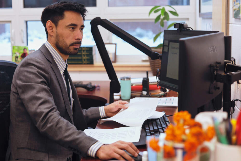 Winooski School District Superintendent Wilmer Chavarria works at his desk. (Amanda Swinhart/AP)