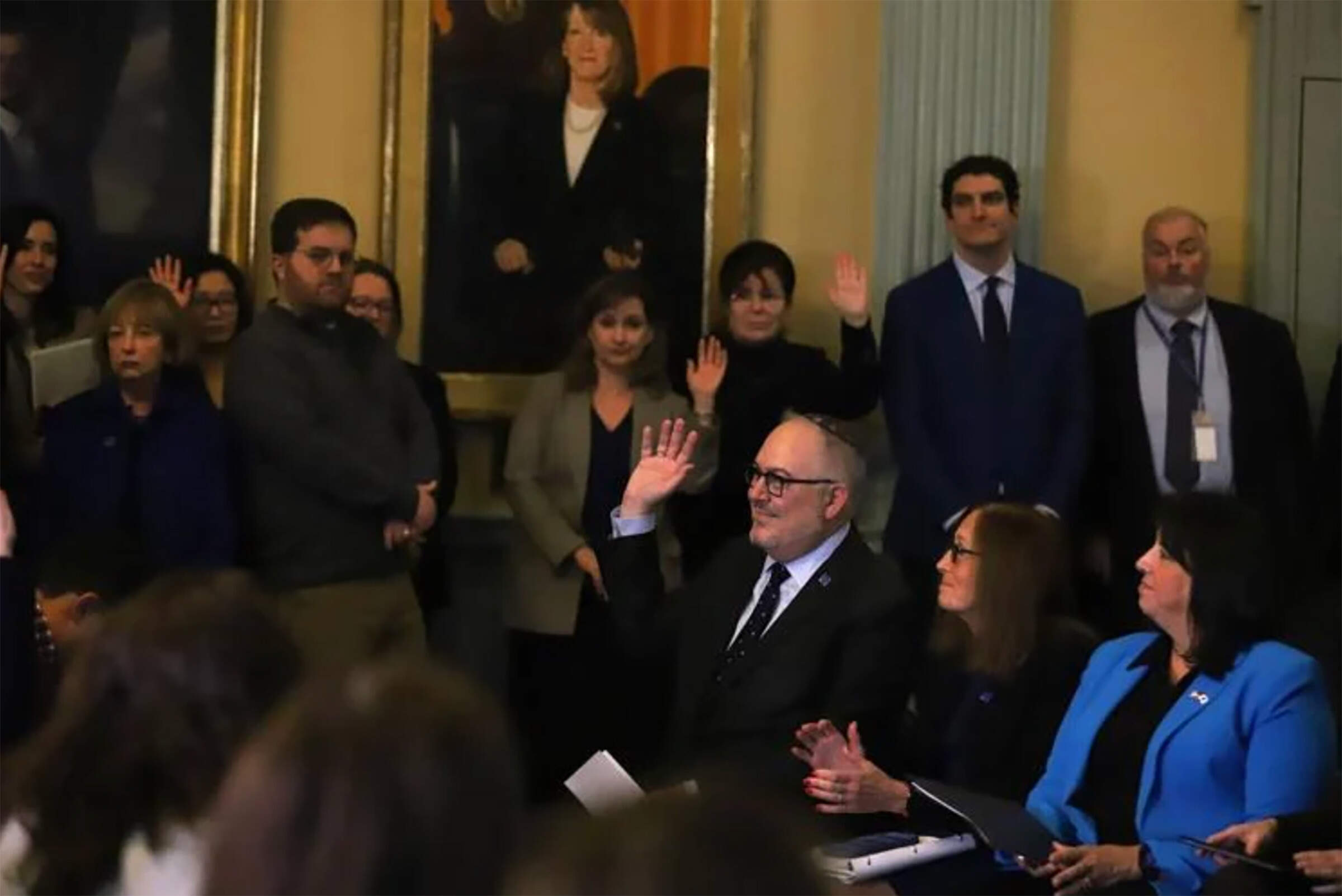 Members of the Special Commission on Combating Antisemitism raise their hands to be recognized during a press conference highlighting the commission's final report at the State House on Wednesday. (Sam Drysdale/SHNS)