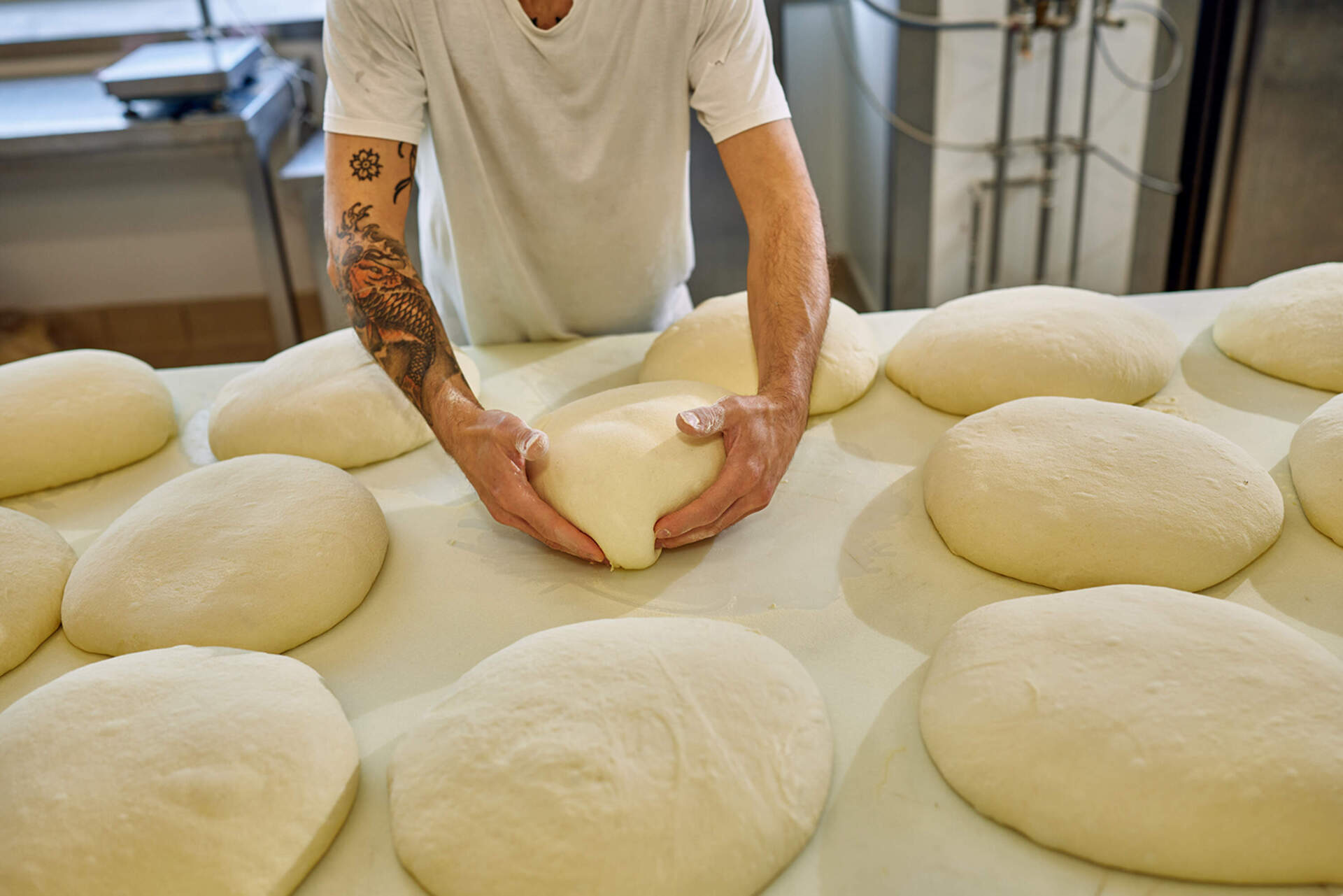 A man shapes dough for one of San Patrignano's bakeries. Some of the breads are eaten by residents, while others are sold throughout the region. (Wilson Santinelli for WBUR)