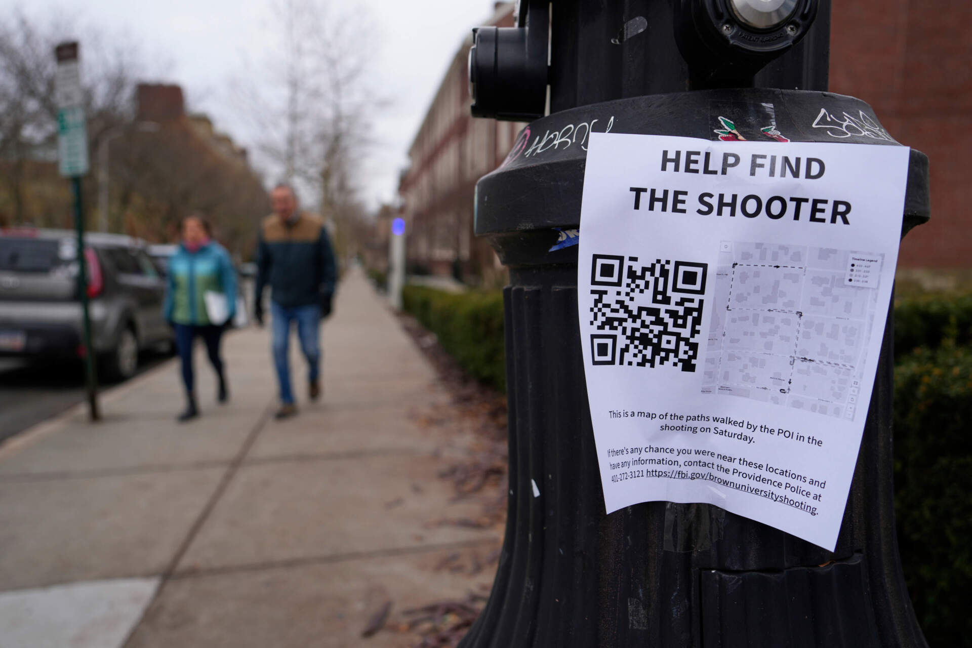 A poster seeking information about the campus shooting suspect is seen at Brown University on Dec. 17 in Providence, R.I. (Robert F. Bukaty/AP)
