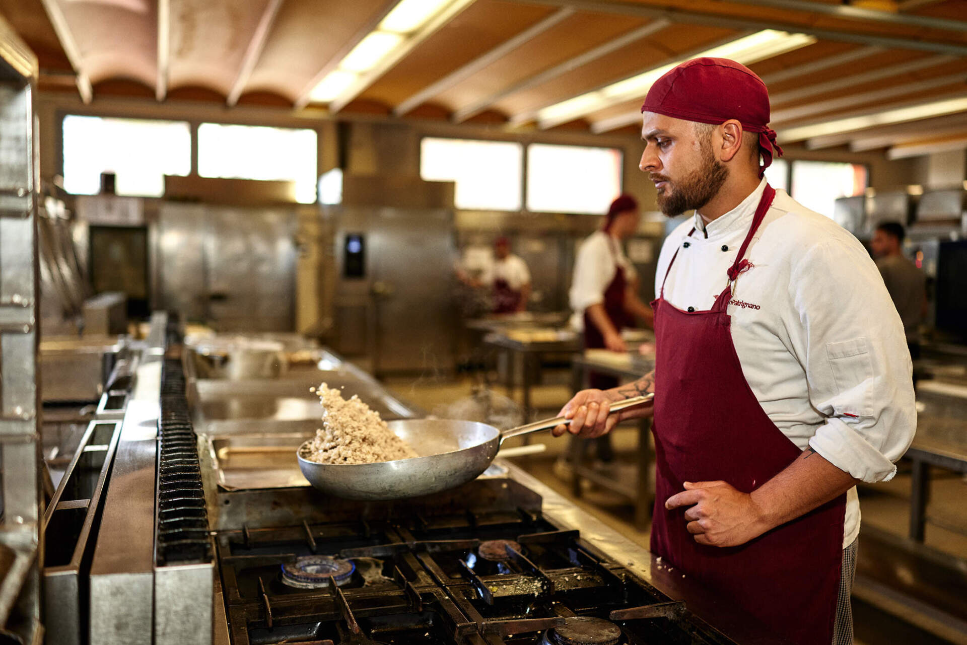 A resident at San Patrignano cooks in the center's kitchen. (Wilson Santinelli for WBUR)