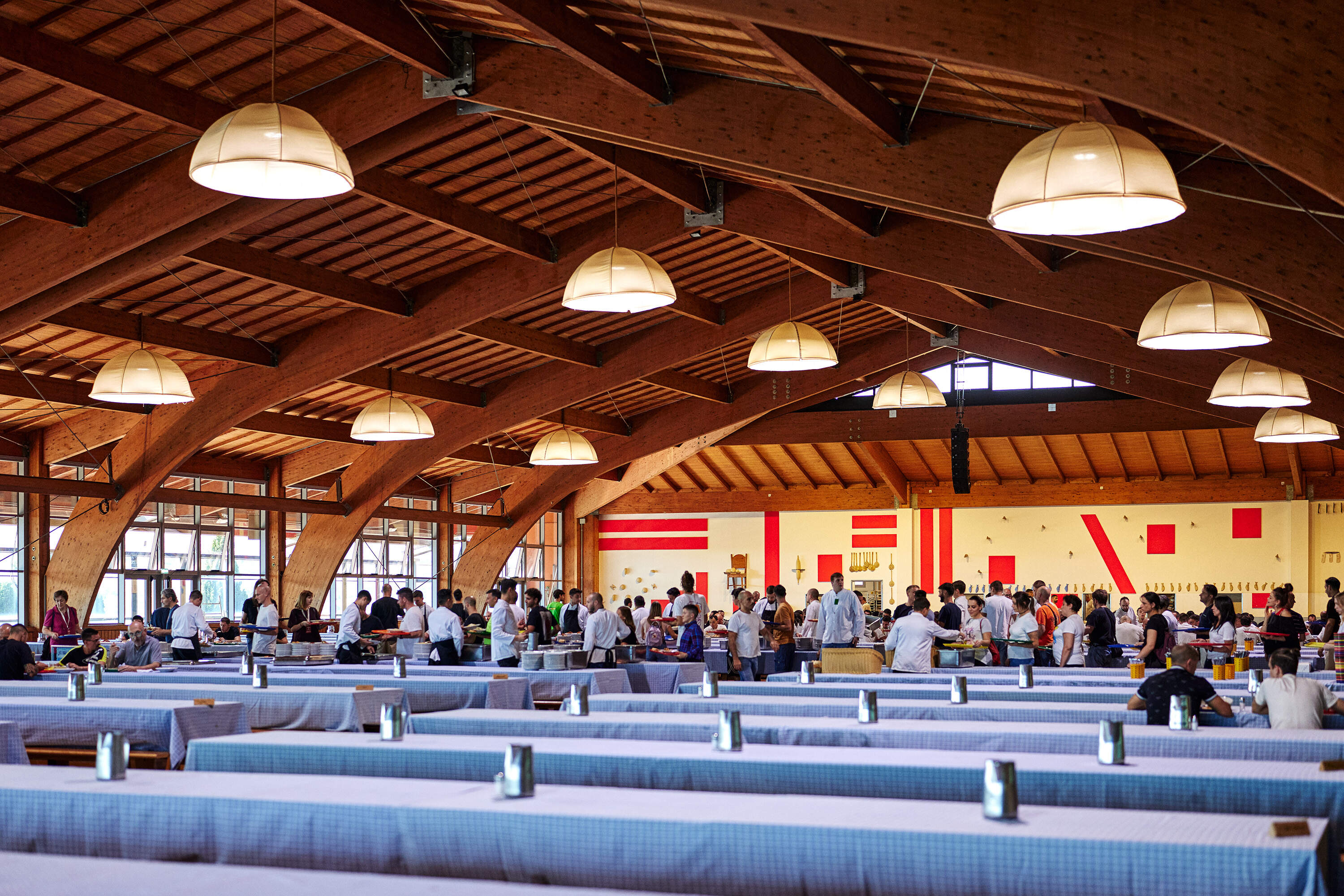 People gather to eat inside the dining hall at San Patrignano. (Wilson Santinelli for WBUR)