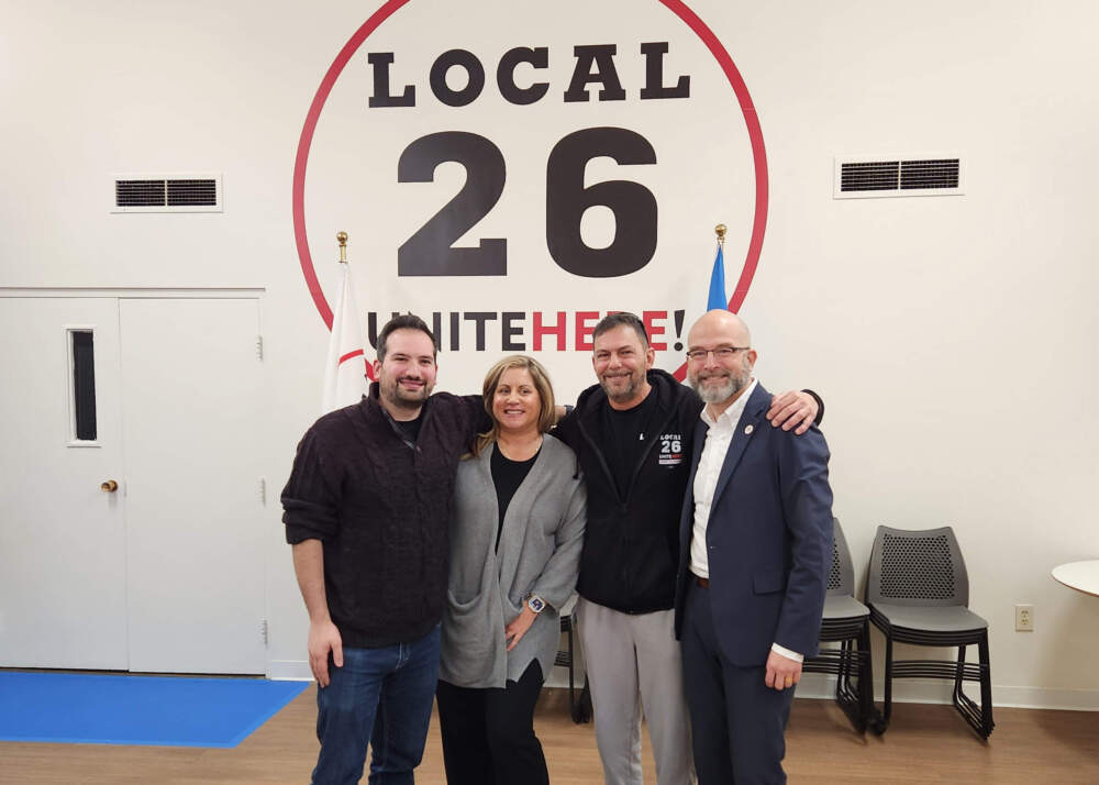 From left, union members Austin Petruzziello, Lauren Casello, Joe Baio and union President Carlos Aramayo pose for a photo after announcing a new contract between the Fenway concession workers union and the park. (Andrea Perdomo-Hernandez/WBUR)