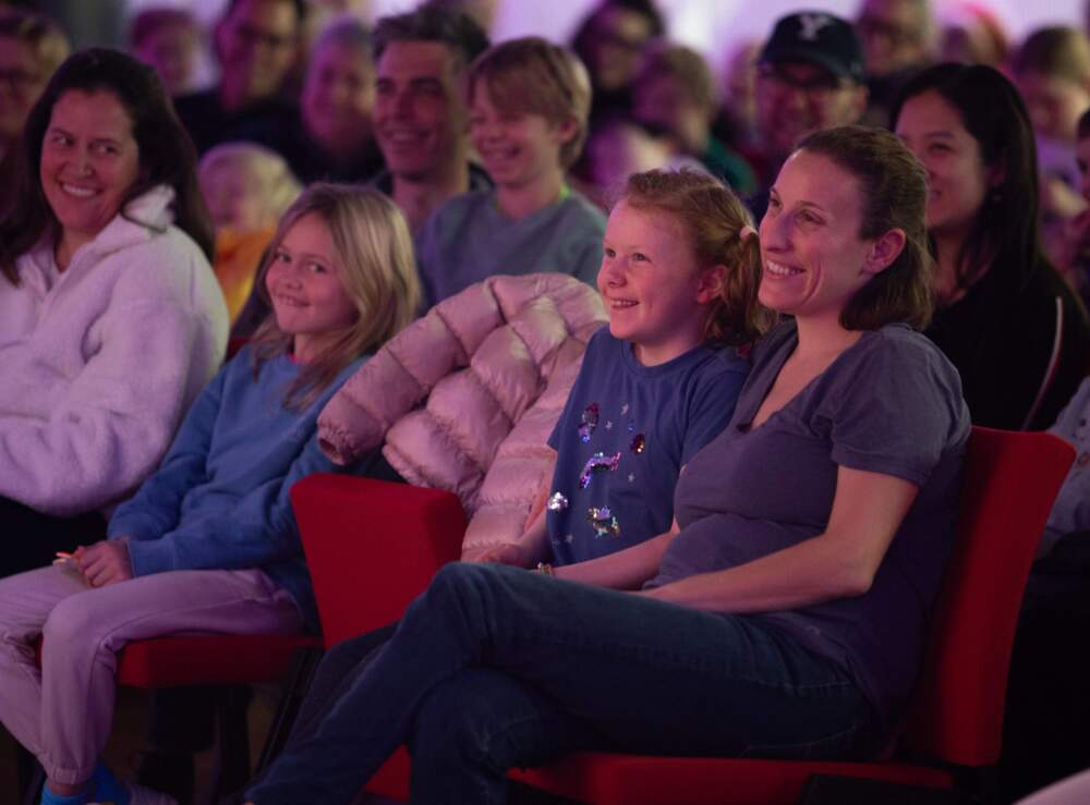 Families enjoying "Greeking Out" live at CitySpace. The show will return in April 2026, as part of our Mega Awesome Super Huge Wicked Fun Podcast Playdate. (Milena Fernsler/WBUR)