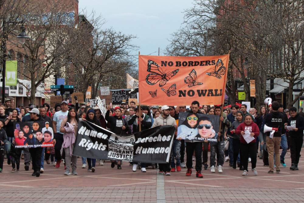 A crowd of several hundred people march with Migrant Justice advocates in Burlington, Vt. in May to protest border agents' arrest of eight farmworkers at a dairy farm in Berkshire, Vt. (Zoe McDonald/Vermont Public)
