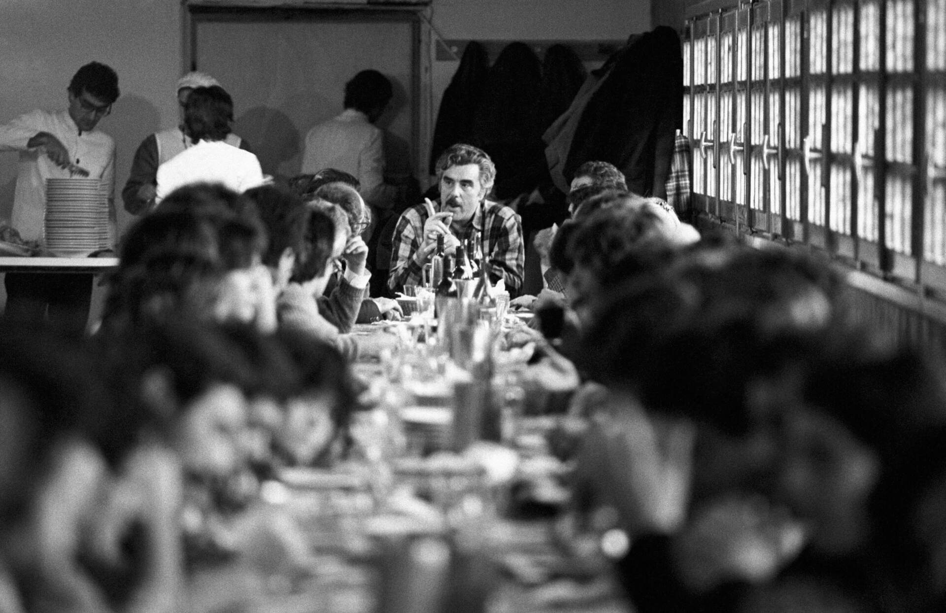 Italian entrepreneur Vincenzo Muccioli eats lunch in the 1980s with some young people living at the San Patrignano rehab that he founded. (Nino Leto/Mondadori via Getty Images)