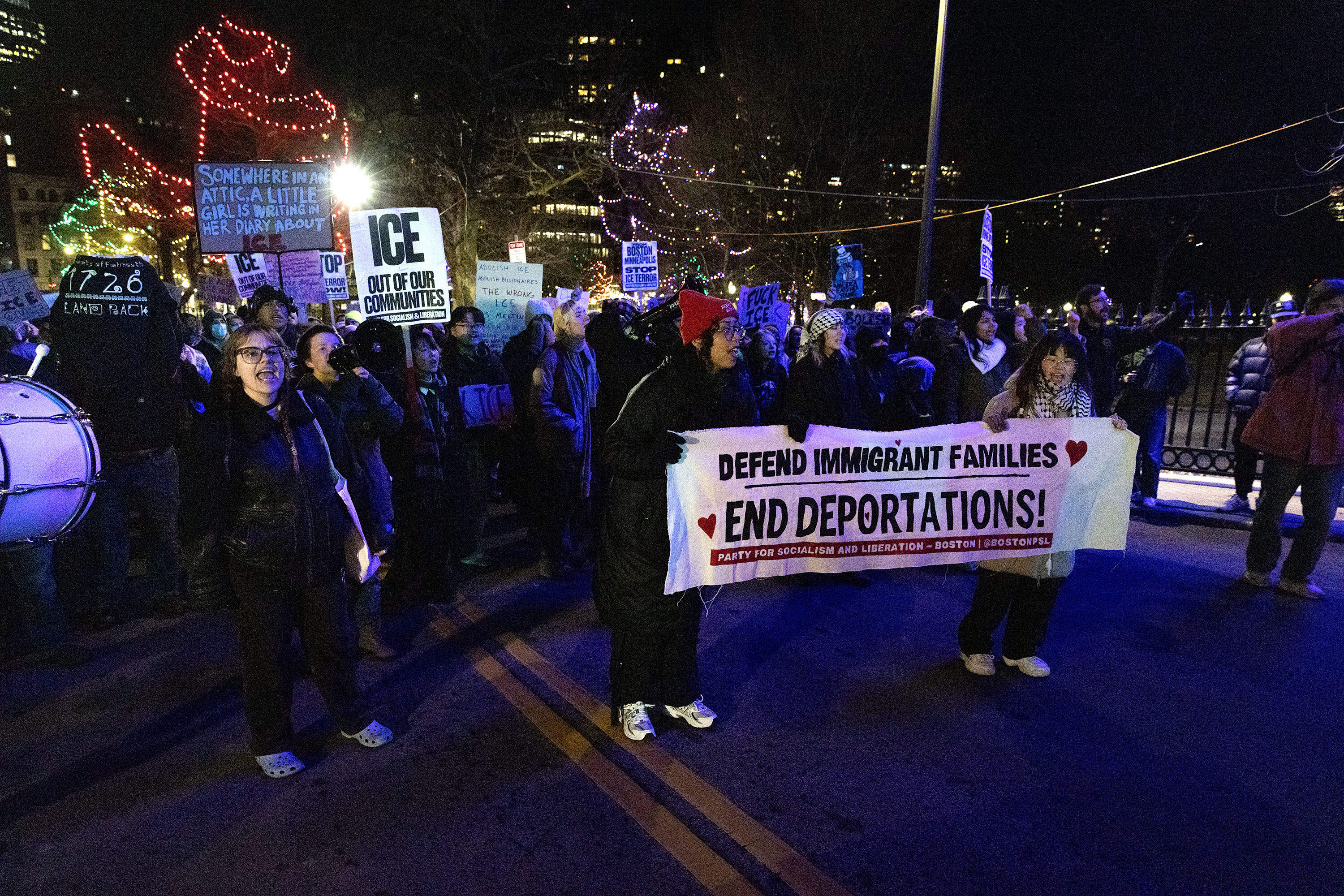 Anti-ICE protesters march up the center of Park Street towards the Massachusetts State House. (Robin Lubbock/WBUR)