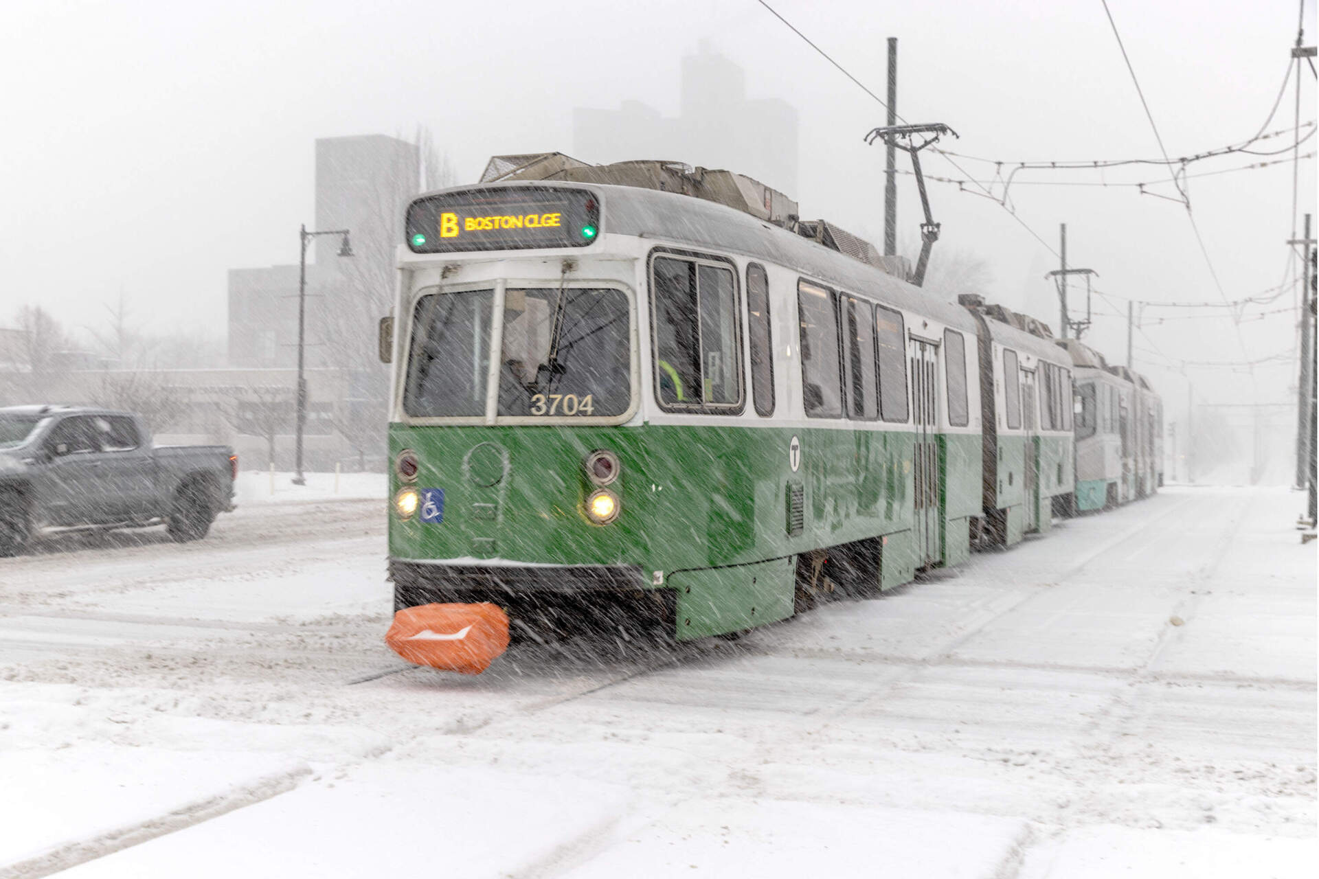 A Green Line MBTA train makes it's way along Commonwealth Ave. during the snowstorm. (Robin Lubbock/WBUR)