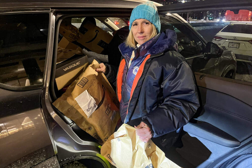 Suzanne Fareri-Early, founder of COPE, filled her SUV with donations that were delivered to her home just before she left for the night's outreach at South Station. (Lynn Jolicoeur/WBUR)