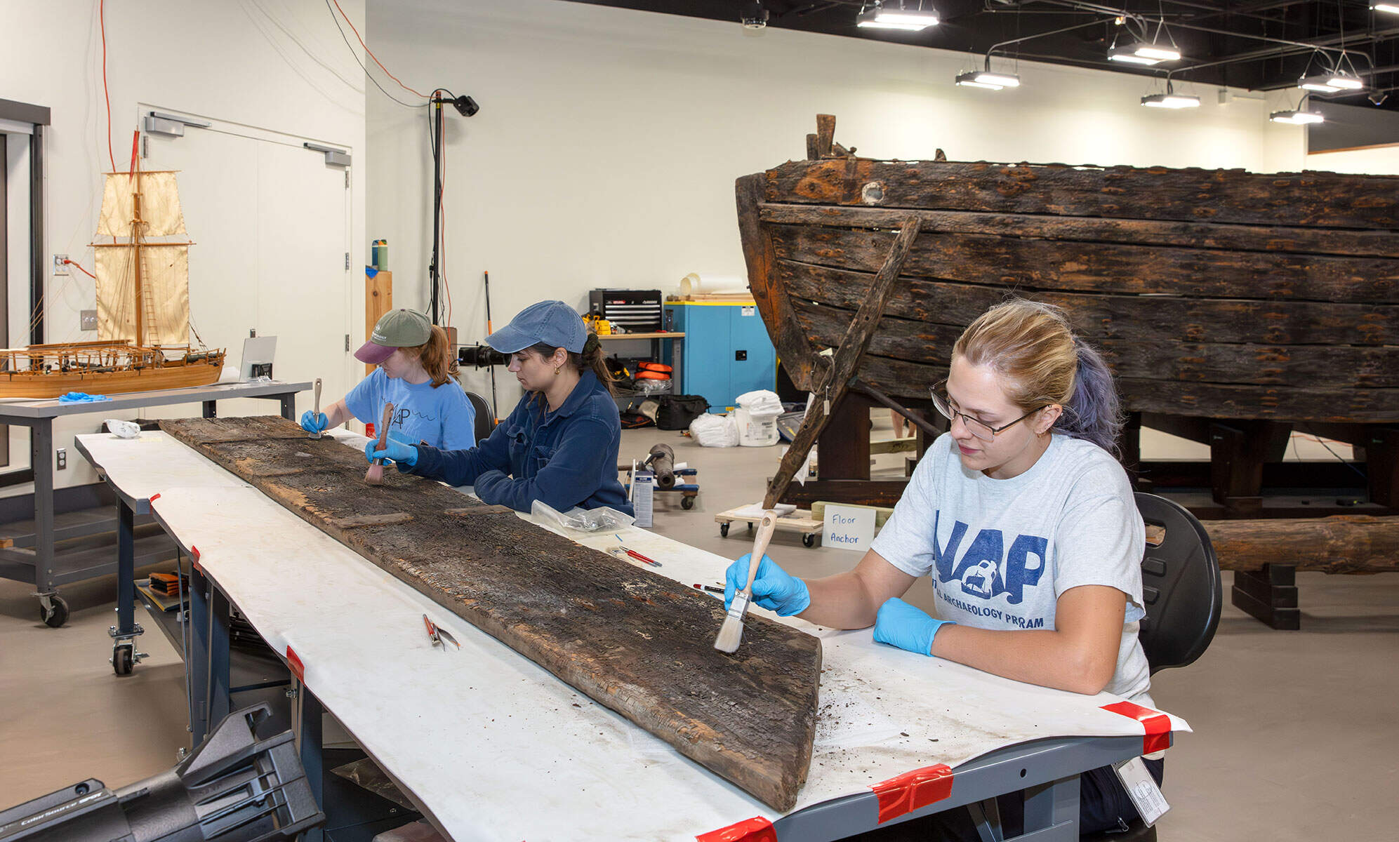 Conservators from Texas A&M's Center for Nautical Archeology, Conservation Research Lab working on the gunboat Philadelphia. (Courtesy of the Smithsonian Institution)