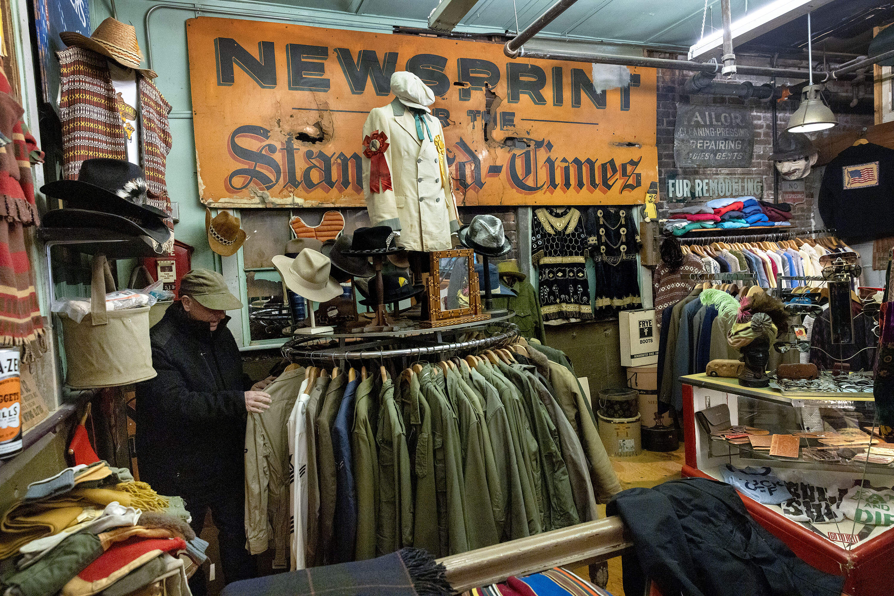 Viens looks through a collection of shirts. (Robin Lubbock/WBUR)