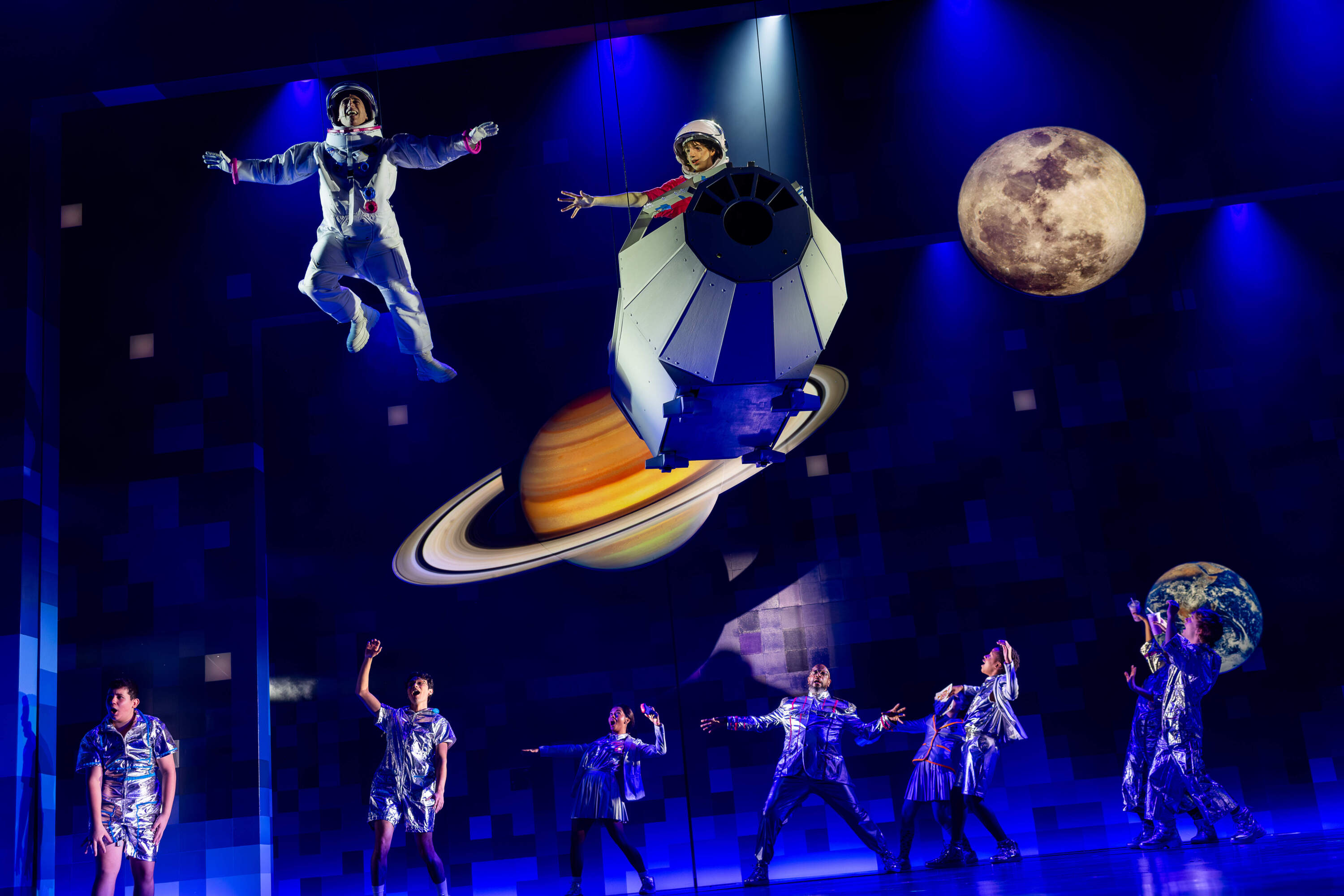 Members of the company watch Garrett McNally (Auggie) and Nathan Salstone (Moon Boy) in A.R.T.'s world-premiere production of "Wonder." (Courtesy of Hawver and Hall)