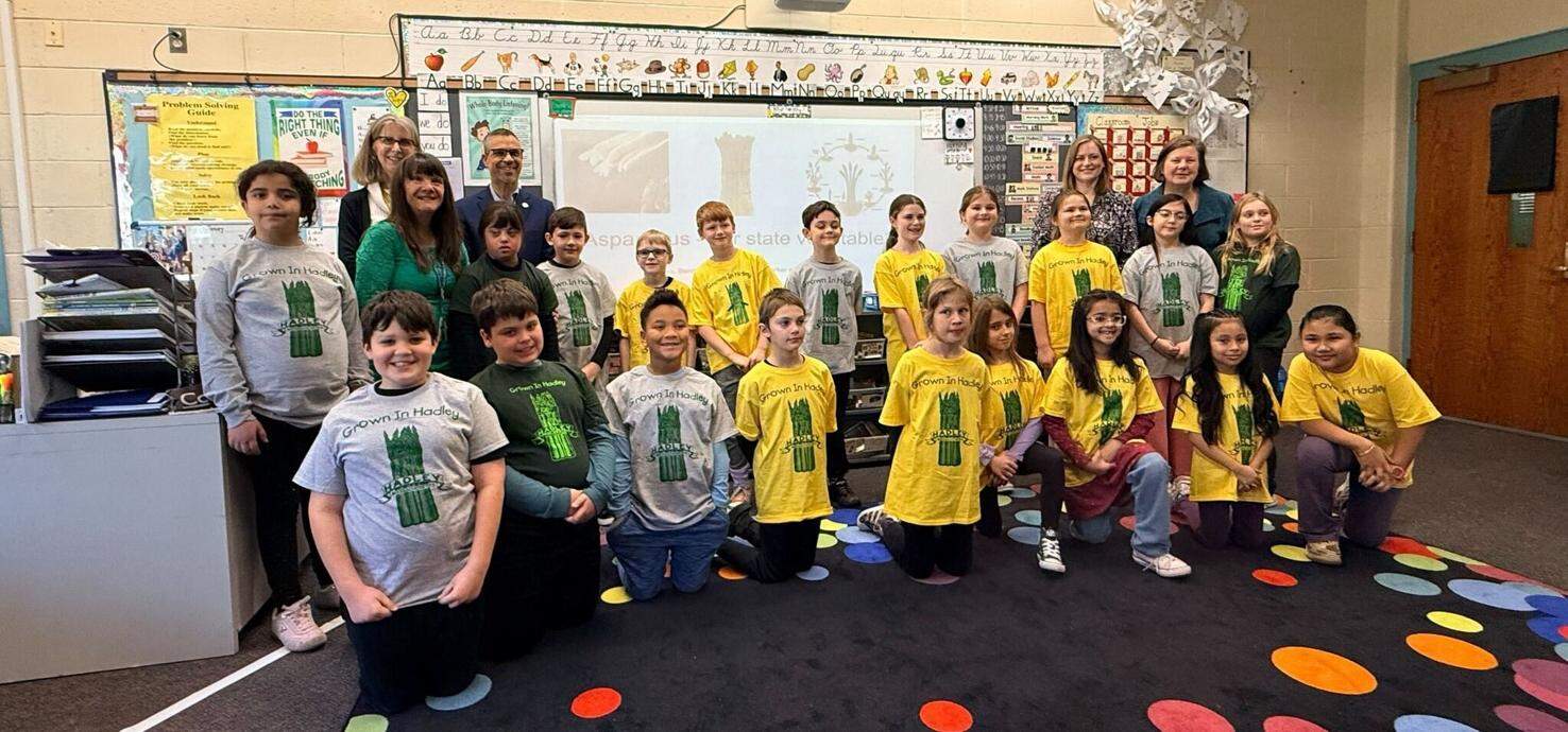 Rep. Gomez and Sen. Comerford with third graders from Hadley Elementary who pitched the idea to make asparagus the official state vegetable. (Courtesy of Sen. Comerford's office via SHNS)