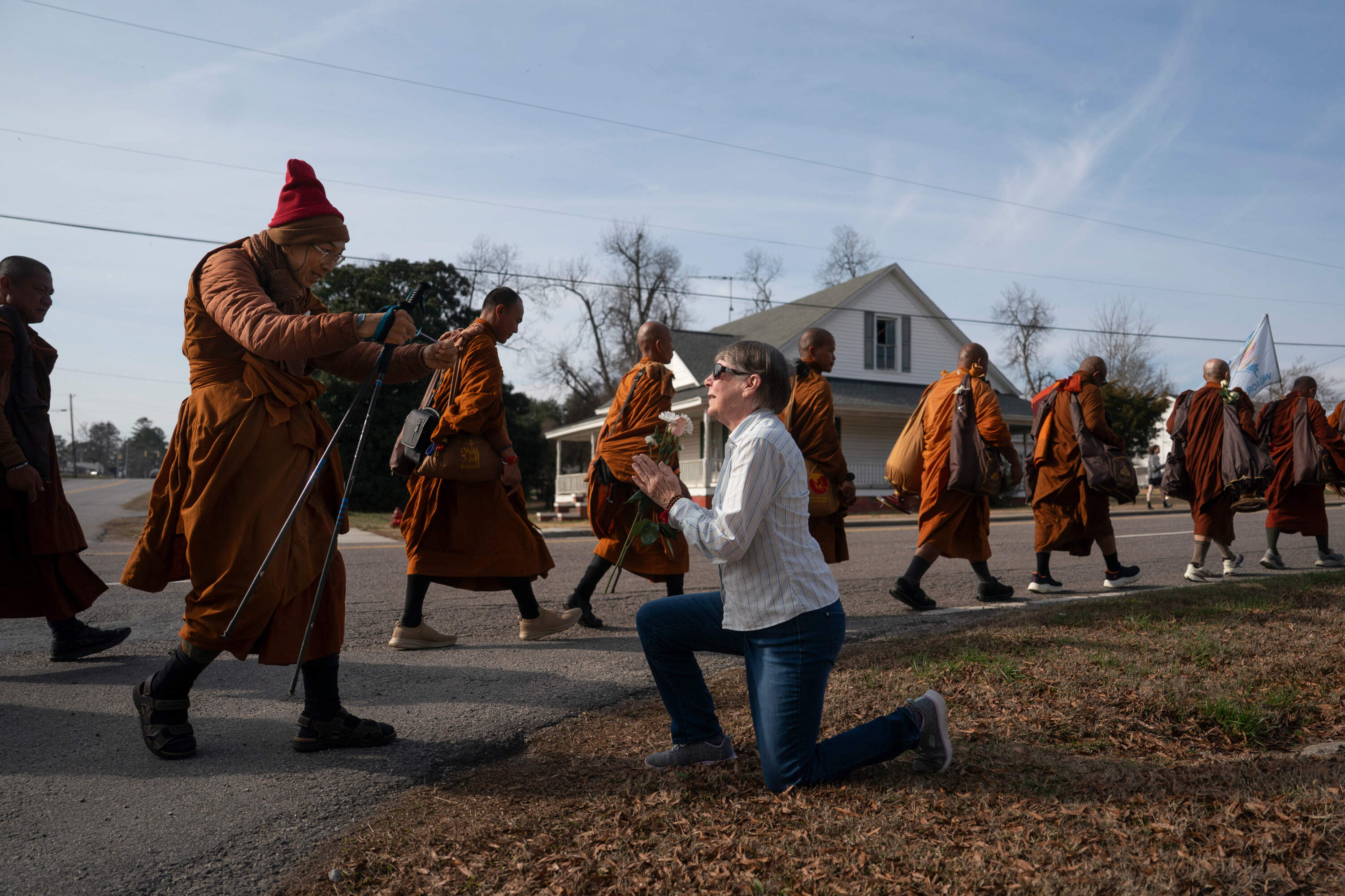 Audrie Pearce greets Buddhist monks who are participating in the "Walk For Peace," Thursday, Jan. 8, 2026, in Saluda, S.C. (Allison Joyce/AP)