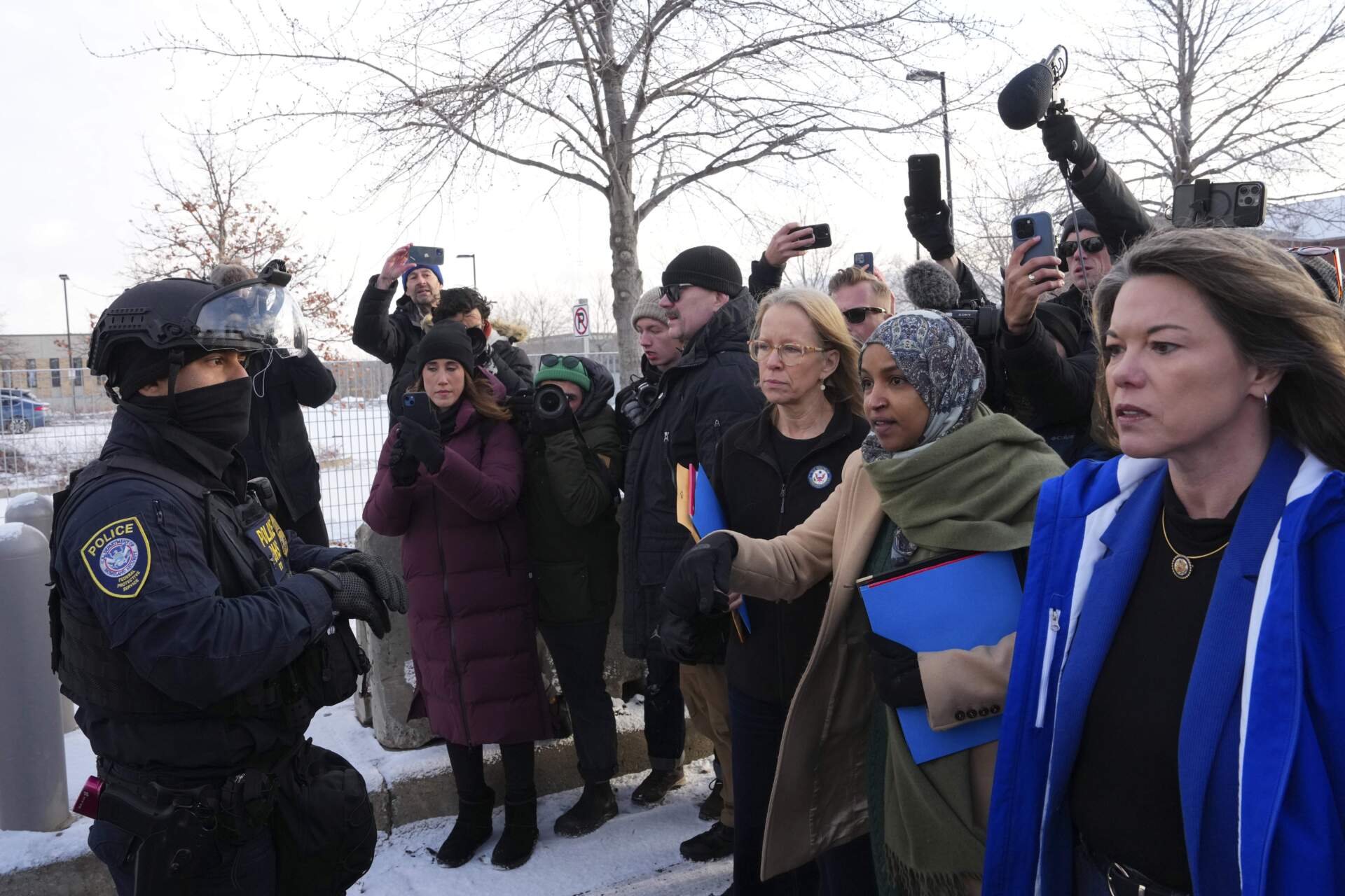 Rep. Kelly Morrison D-Minn., center, Rep. Ilhan Omar, D-Minn., second from the right, and Rep. Angie Craig, D-Minn., far right, at the Bishop Whipple Federal Building, Saturday, Jan. 10, 2026, in Minneapolis. (Adam Gray/AP)