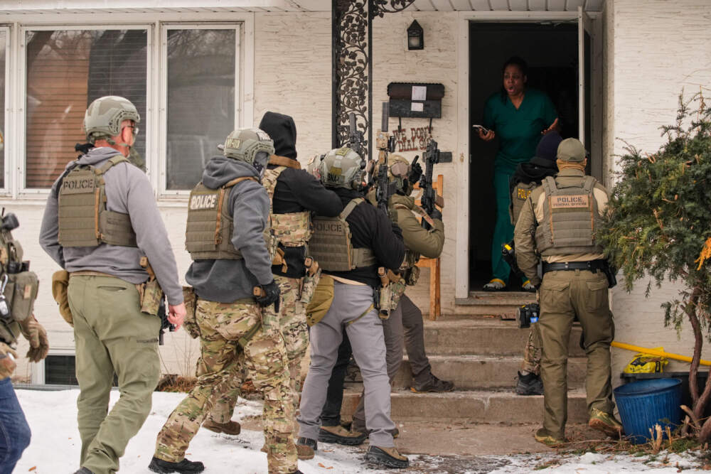 Teyana Gibson Brown, second from right, wife of Garrison Gibson, reacts after a federal immigration officer used a battering ram to break down a door before arresting Garrison Gibson, Sunday, Jan. 11, 2026, in Minneapolis. (John Locher/AP)