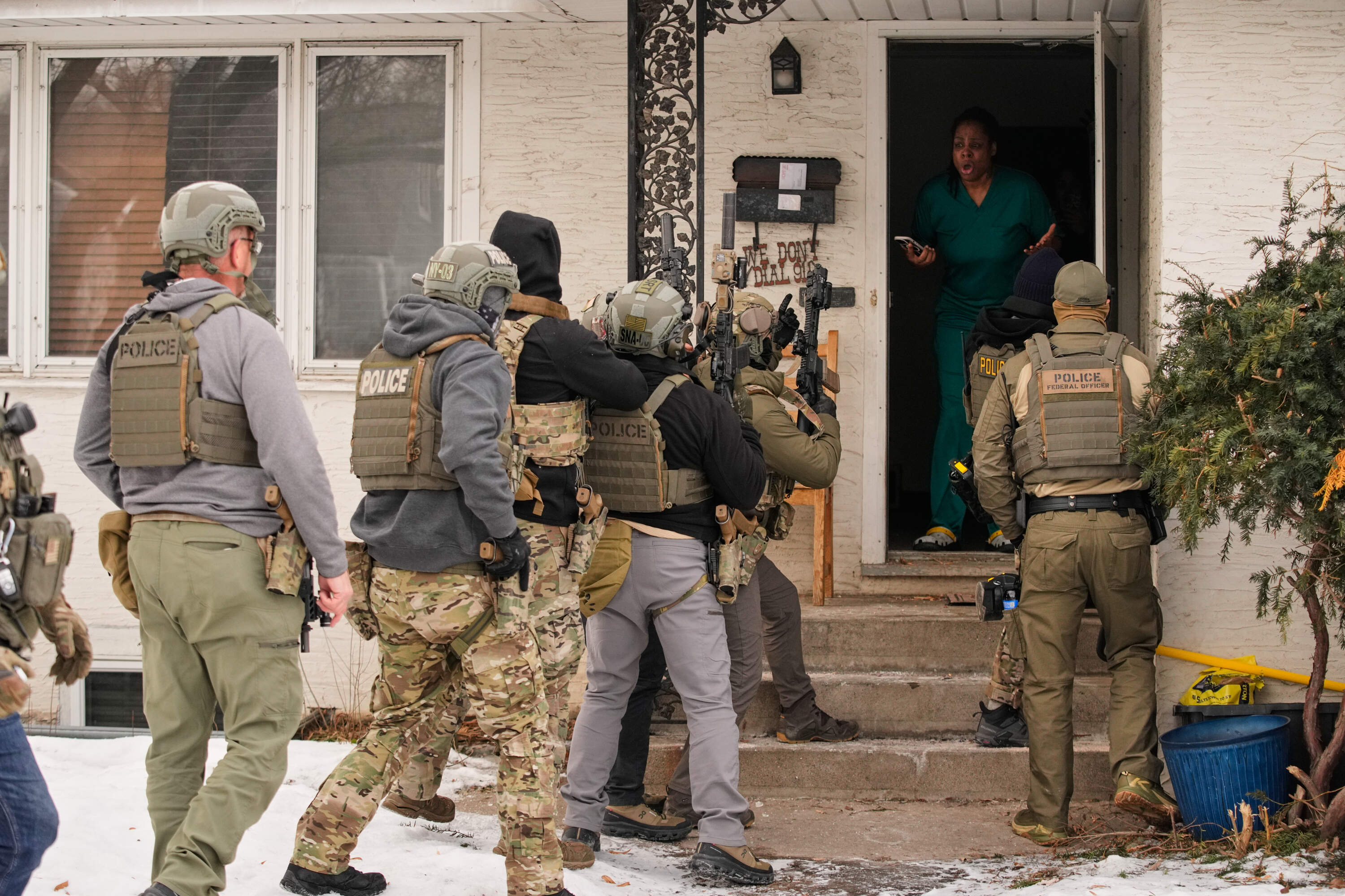 Teyana Gibson Brown, second from right, wife of Garrison Gibson, reacts after a federal immigration officer used a battering ram to break down a door before arresting Garrison Gibson, Sunday, Jan. 11, 2026, in Minneapolis. (John Locher/AP)