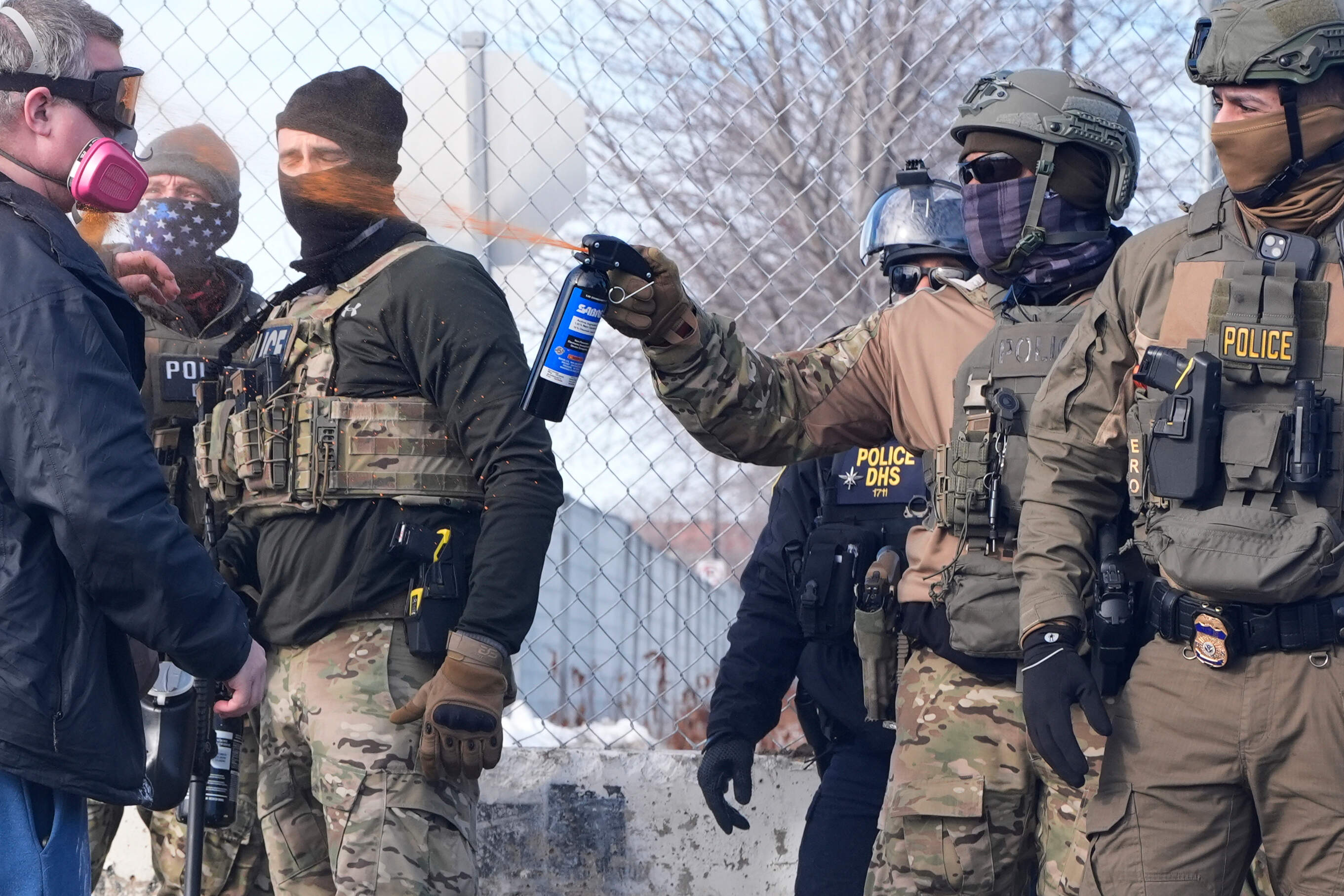 An Immigration and Customs Enforcement (ICE) agent shoots pepper spray at a protester outside of the Bishop Whipple Federal Building, Monday, Jan. 12, 2026, in Minneapolis. (Jen Golbeck/AP)