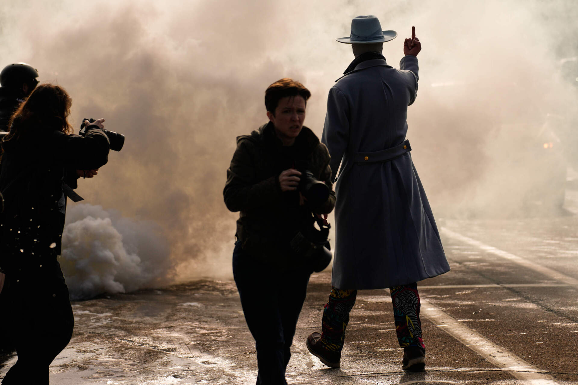 A man gestures as he walks toward a cloud of tear gas that was deployed by federal immigration officers Monday, Jan. 12, 2026, in Minneapolis. (John Locher/AP)