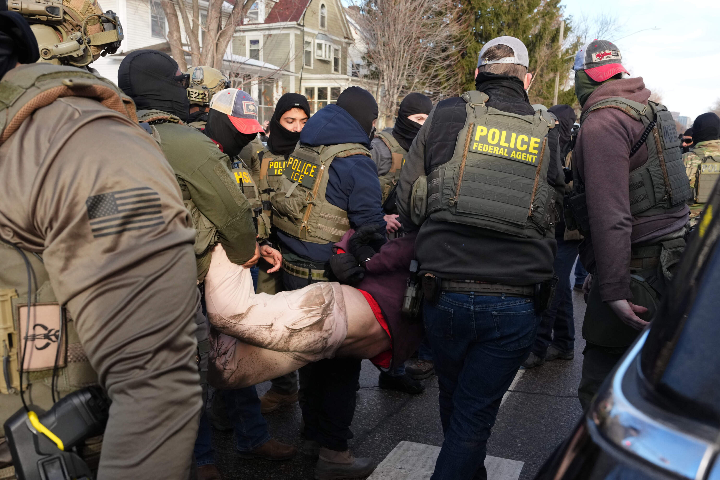 A protester is detained by federal agents near the scene where Renee Good was fatally shot by an ICE officer last week, Tuesday, Jan. 13, 2026, in Minneapolis. (Adam Gray/AP)