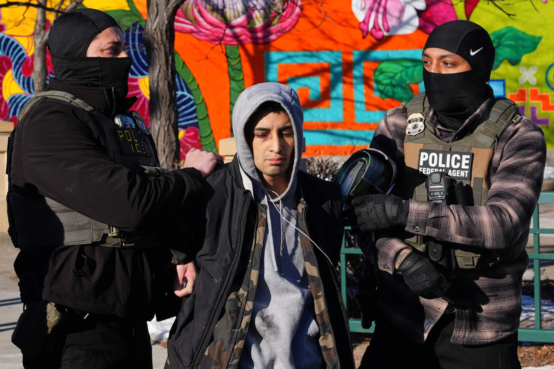 A person is detained by federal immigration officers on Lake Street in Minneapolis, Wednesday, Jan. 14, 2026. (Adam Gray/AP)
