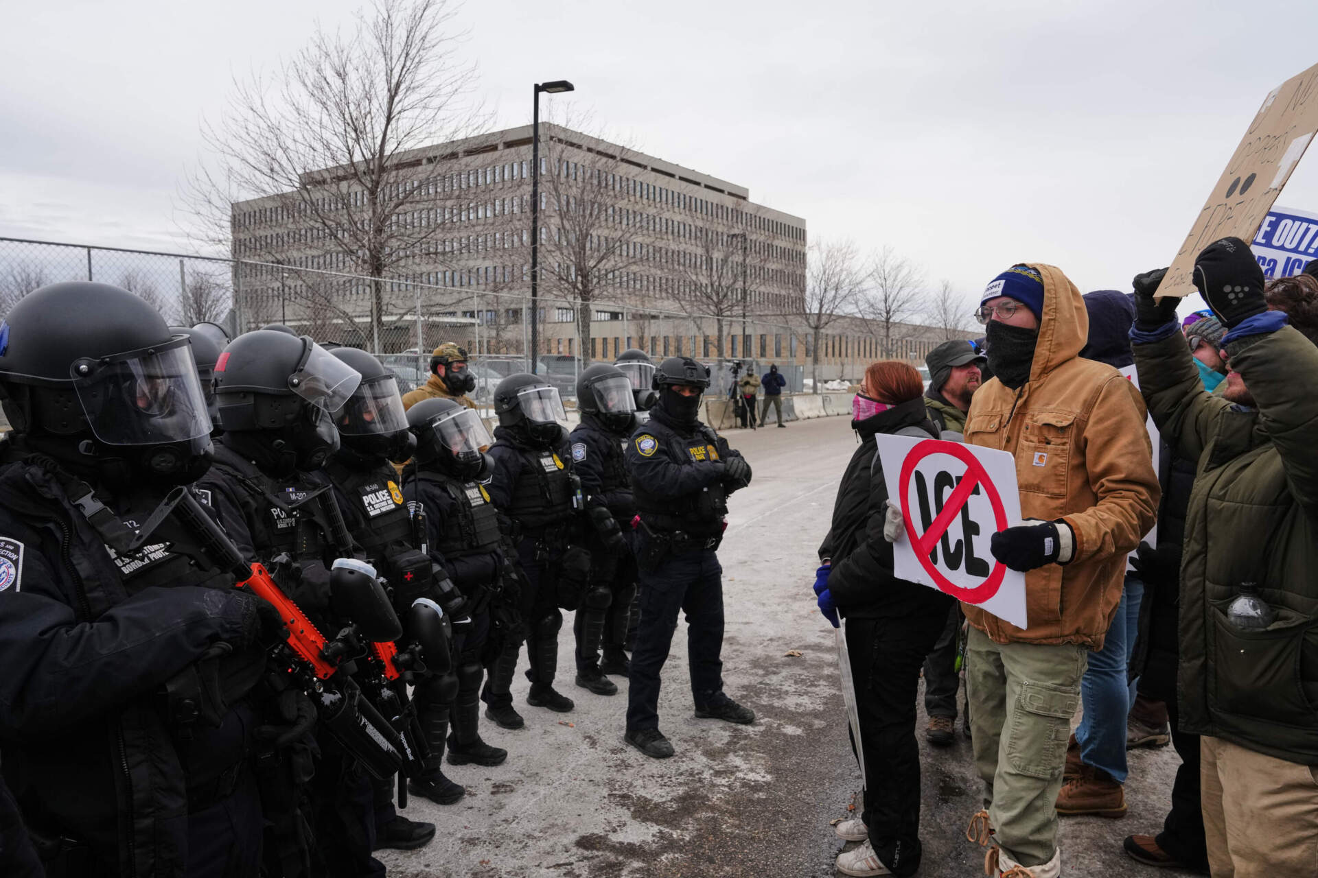 Federal immigration officers confront protesters outside Bishop Henry Whipple Federal Building, Thursday, Jan. 15, 2026, in Minneapolis. (Adam Gray/AP)