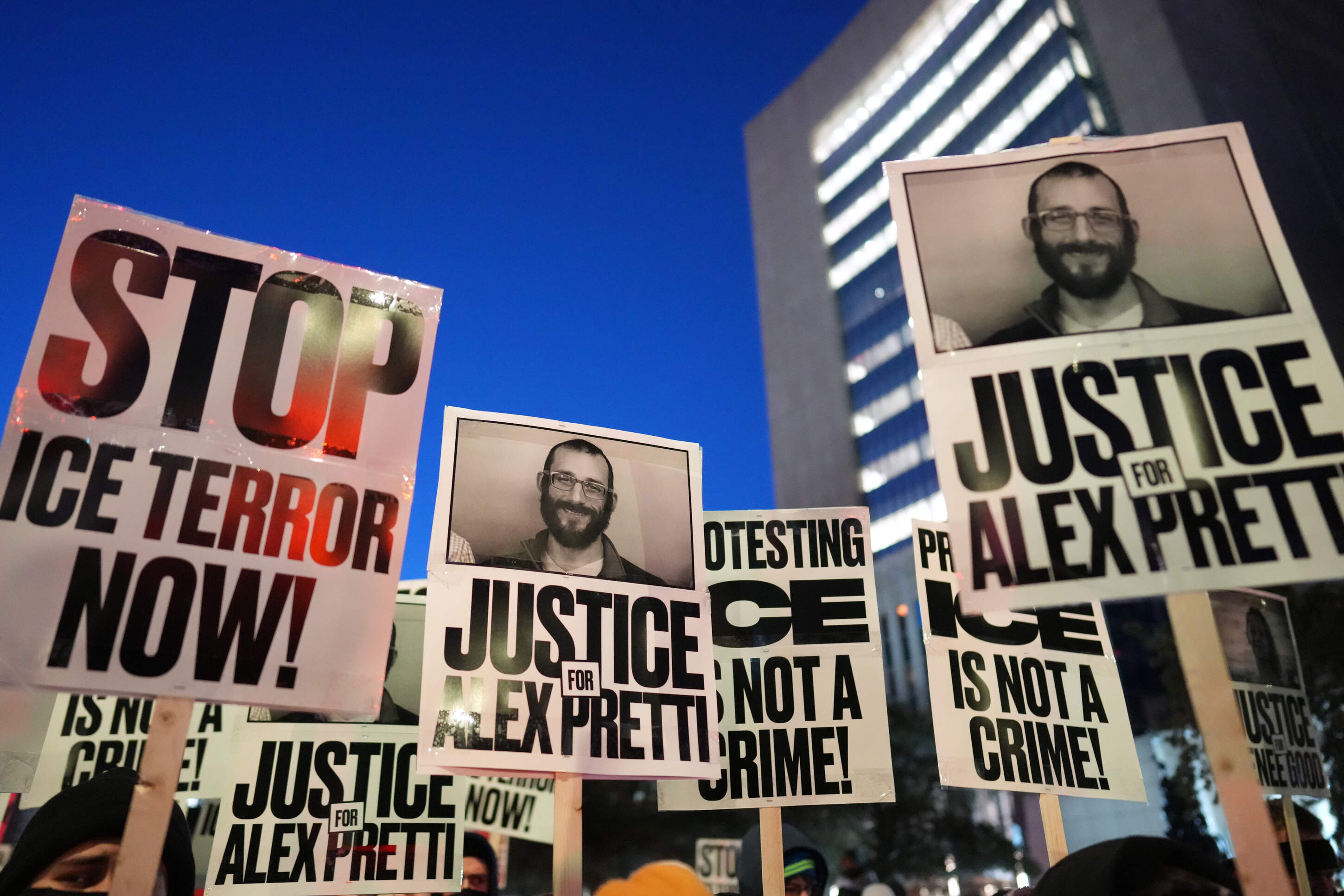 Demonstrators hold signs during a rally against federal immigration enforcement at Federal Courthouse Plaza on Tuesday, Jan. 27, 2026, in Minneapolis. (Adam Gray/AP)