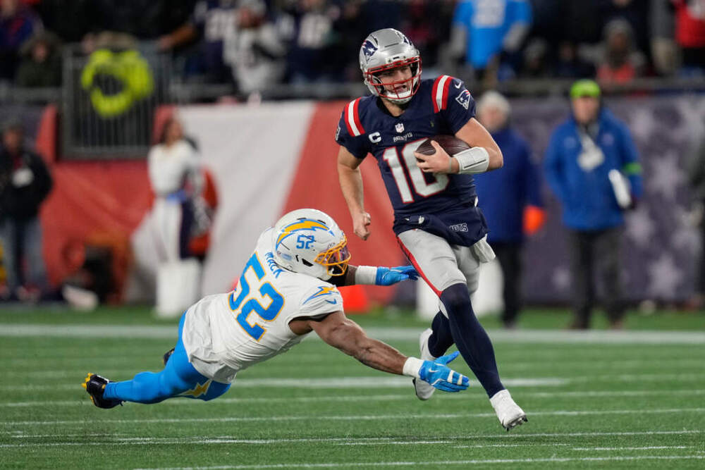 New England Patriots quarterback Drake Maye (10) avoids a tackle by Los Angeles Chargers linebacker Khalil Mack (52) in the first half of an NFL wild-card playoff football game. (Charles Krupa/AP)