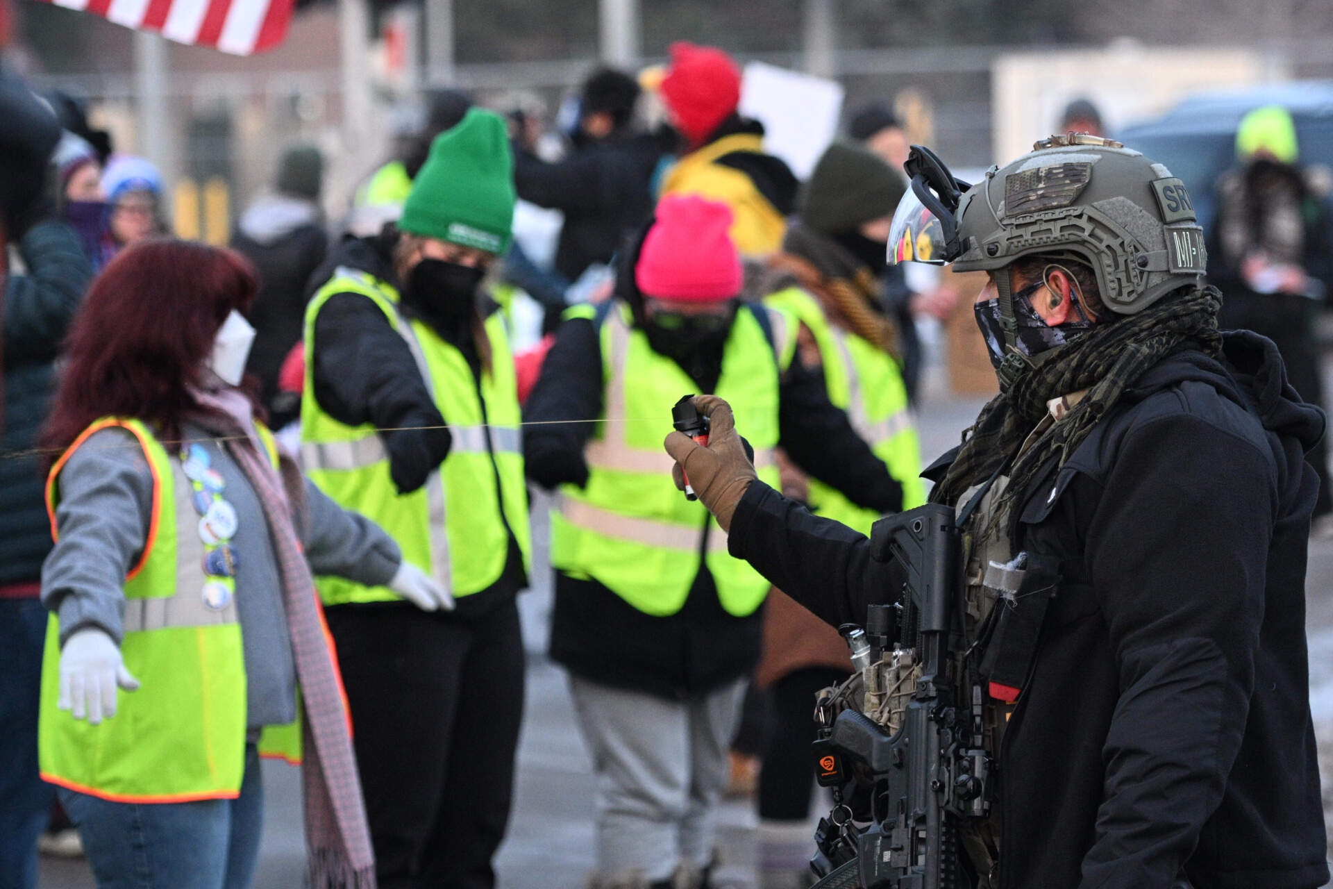 Law enforcement uses a chemical agent on protesters outside the Bishop Henry Whipple Federal Building on Thursday, Jan. 8, in Minneapolis. (Tom Baker/AP)