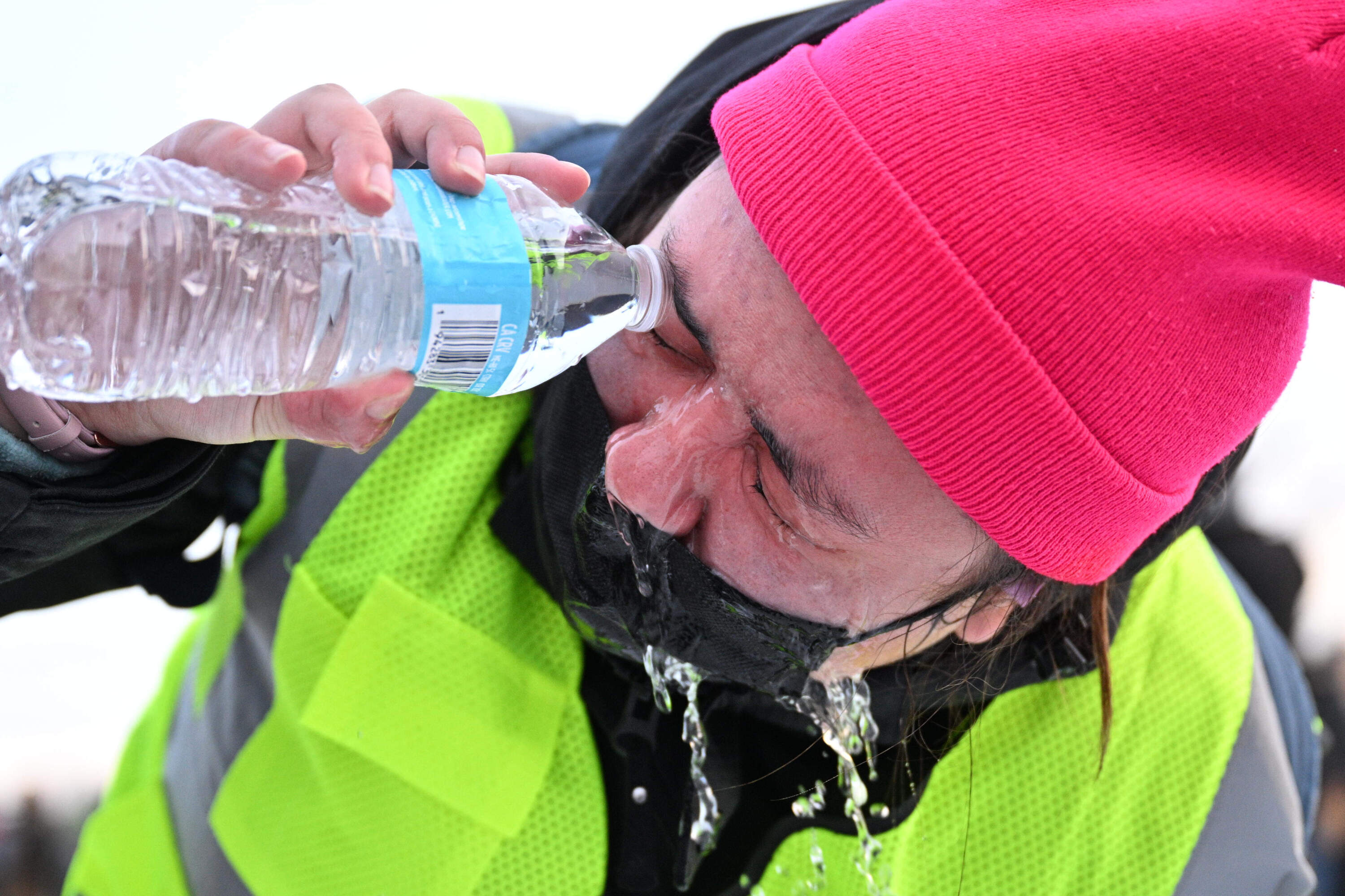 A protester pours water in their eye after confronting law enforcement outside the Bishop Henry Whipple Federal Building on Thursday in Minneapolis. (Tom Baker/AP)