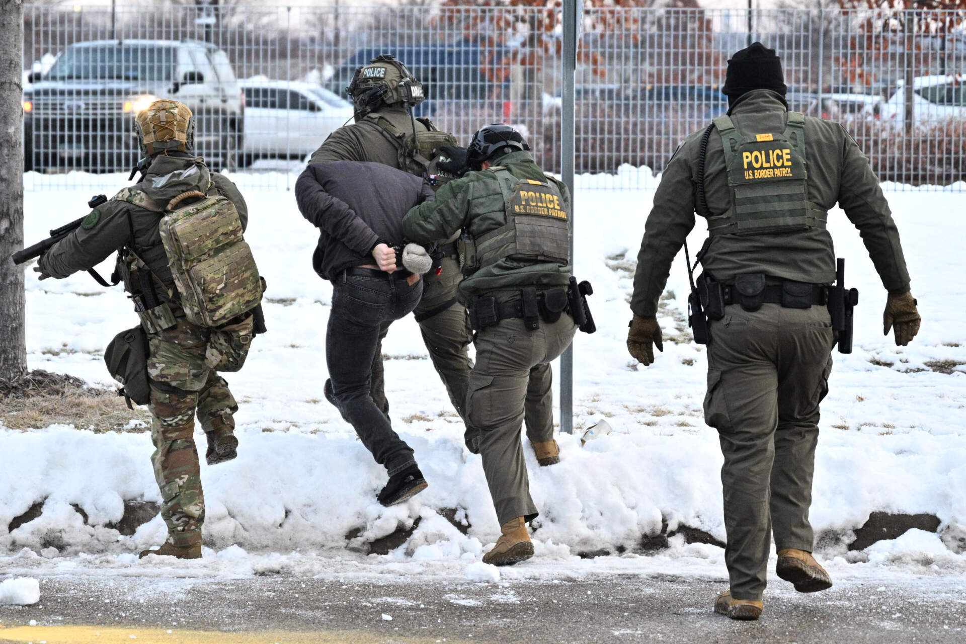 Federal agents confront protesters outside the Bishop Henry Whipple Federal Building on Thursday, Jan. 8, in Minneapolis. (Tom Baker/AP)