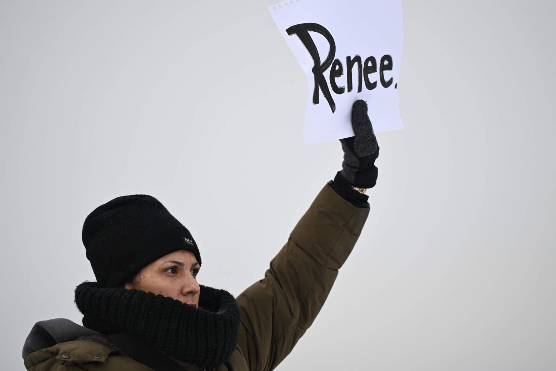 A protester holds up a sign reading "Renee," the name of the woman shot and killed by a U.S. Immigration and Customs Enforcement officer, outside the Bishop Henry Whipple Federal Building on Thursday in Minneapolis. (Tom Baker/AP)