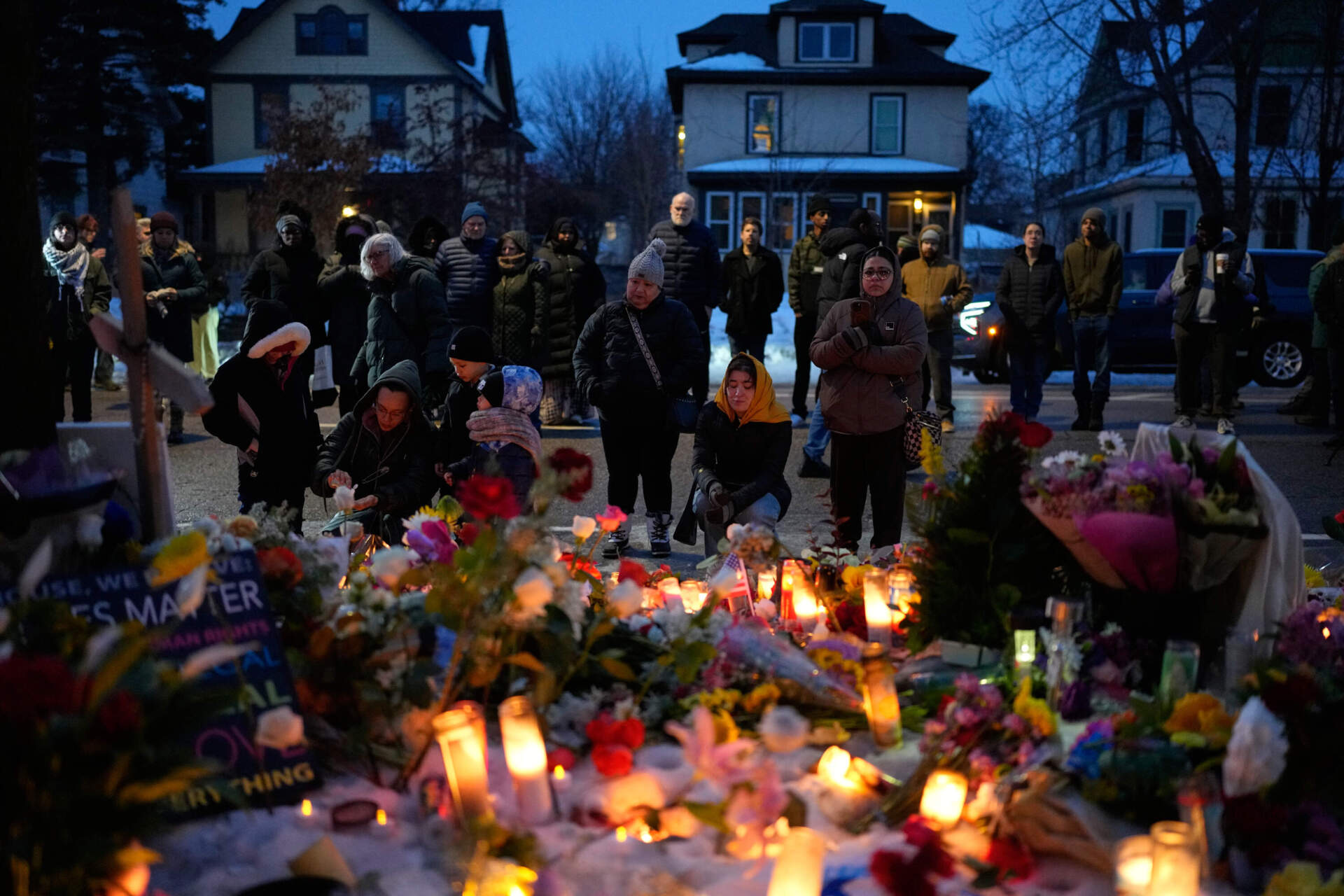 People gather around a memorial honoring Renee Good, who was fatally shot by an ICE officer, near the site of the shooting in Minneapolis, on Thursday, Jan. 8. (John Locher/AP)