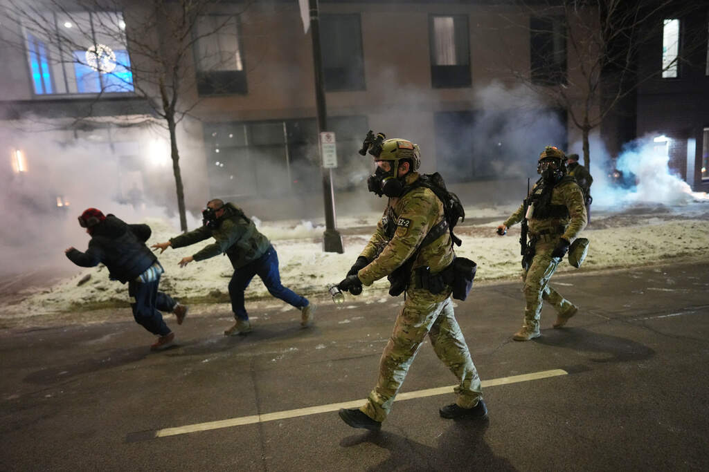 Federal agents try to clear demonstrators using tear gas during a protest in response to federal immigration enforcement operations in Minneapolis on Sunday, Jan. 25, 2026. (Adam Gray/AP)
