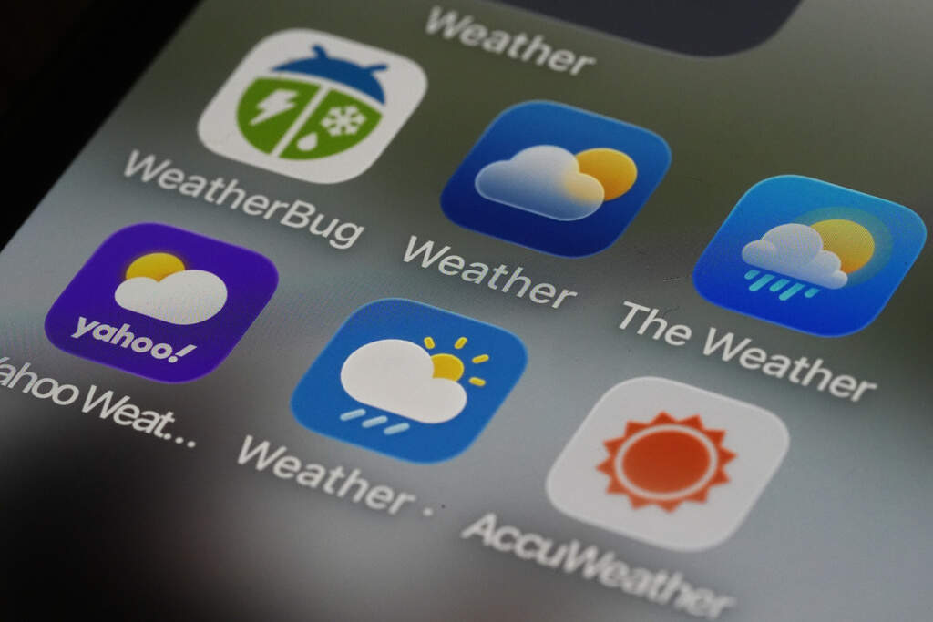 Various weather apps arranged on a smartphone. (AP Photo/Matt Rourke)