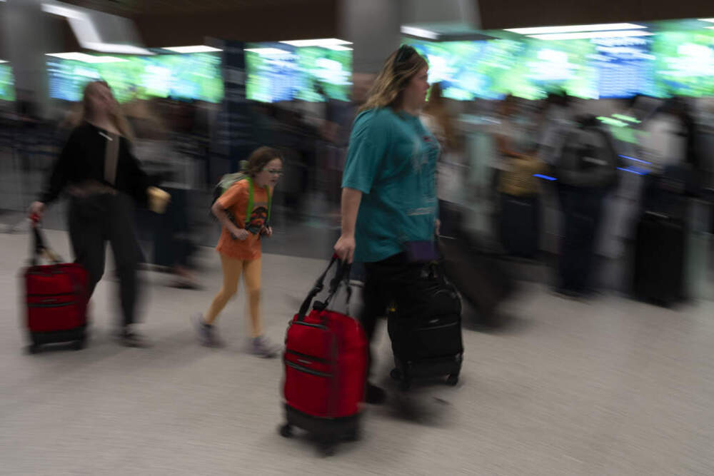 A family walks past a ticketing area at the Los Angeles International Airport in Los Angeles on Sept. 1, 2023. (AP Photo/Jae C. Hong, File)