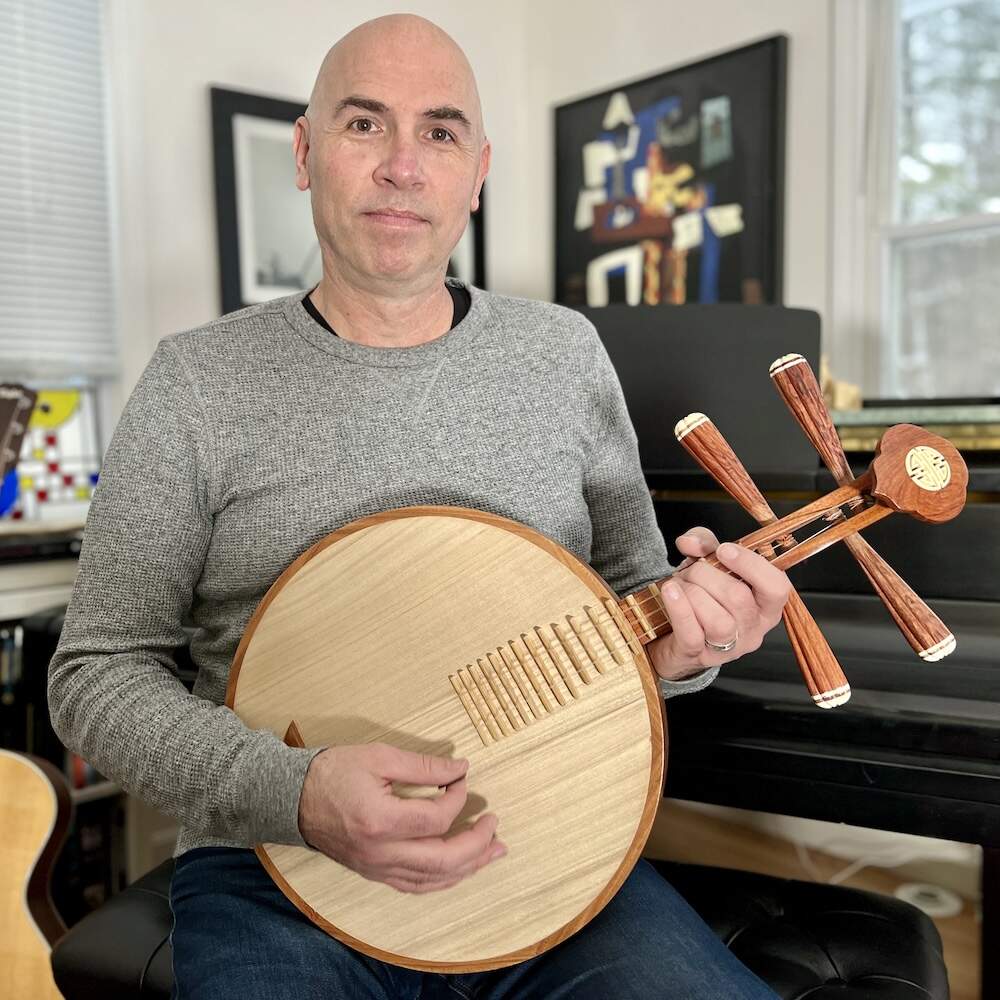 Eric Shimelonis plays the Vietnamese lute known as the đàn tứ. (image courtesy of Rebecca Sheir)
