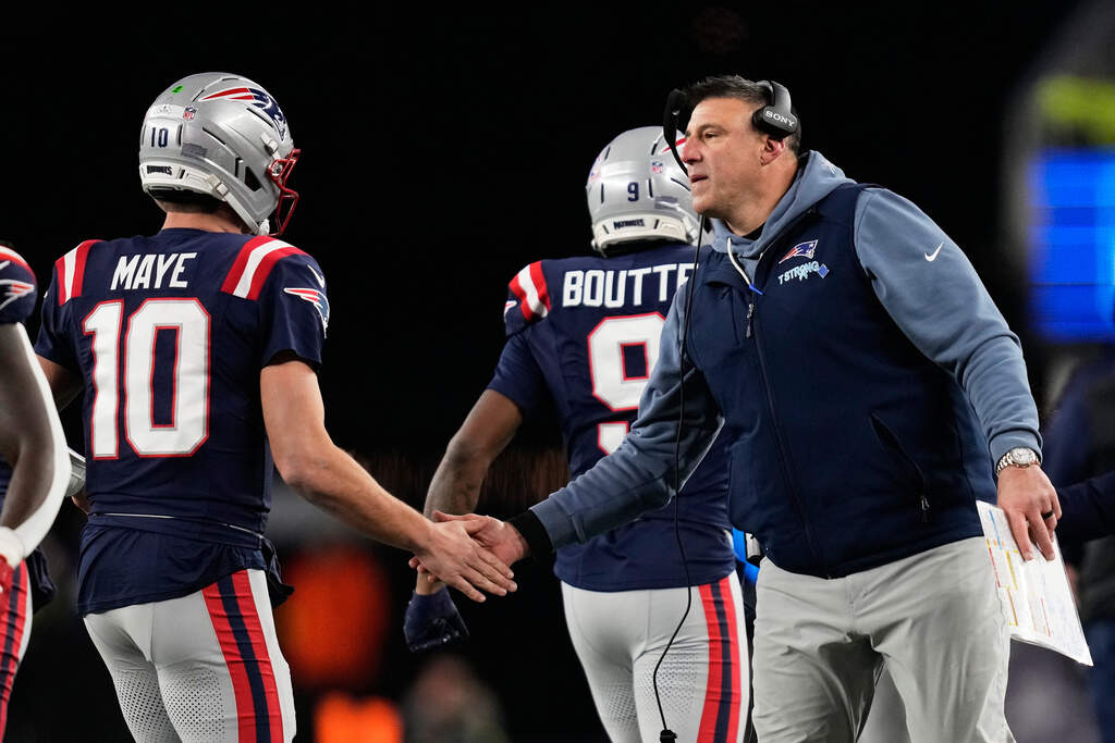 New England Patriots head coach Mike Vrabel, right, greets quarterback Drake Maye during a game against the Miami Dolphins. (Charles Krupa/AP)