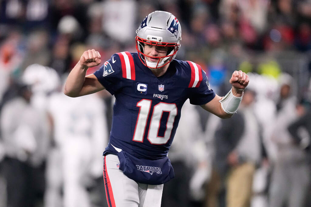 New England Patriots quarterback Drake Maye celebrates after a touchdown scored by running back TreVeyon Henderson during the second half of an NFL football game against the Miami Dolphins in Foxborough, Mass., Sunday, Jan. 4, 2026. (Charles Krupa/AP)