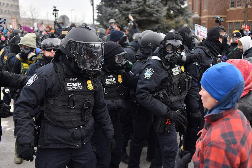 Federal law enforcement agents confront anti-ICE protesters during a demonstration outside the Bishop Whipple Federal Building in Minneapolis, Minnesota, on January 15, 2026. (Octavio Jones / AFP via Getty Images)