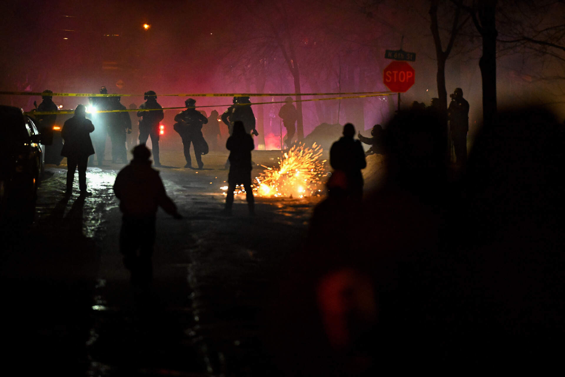 Law enforcement officers clash with protesters at the scene where a man was allegedly shot in the leg during a federal immigration enforcement operation in north Minneapolis. Federal agents are conducting a thirty day immigration operation in the state. (Joshua Lott/The Washington Post via Getty Images)
