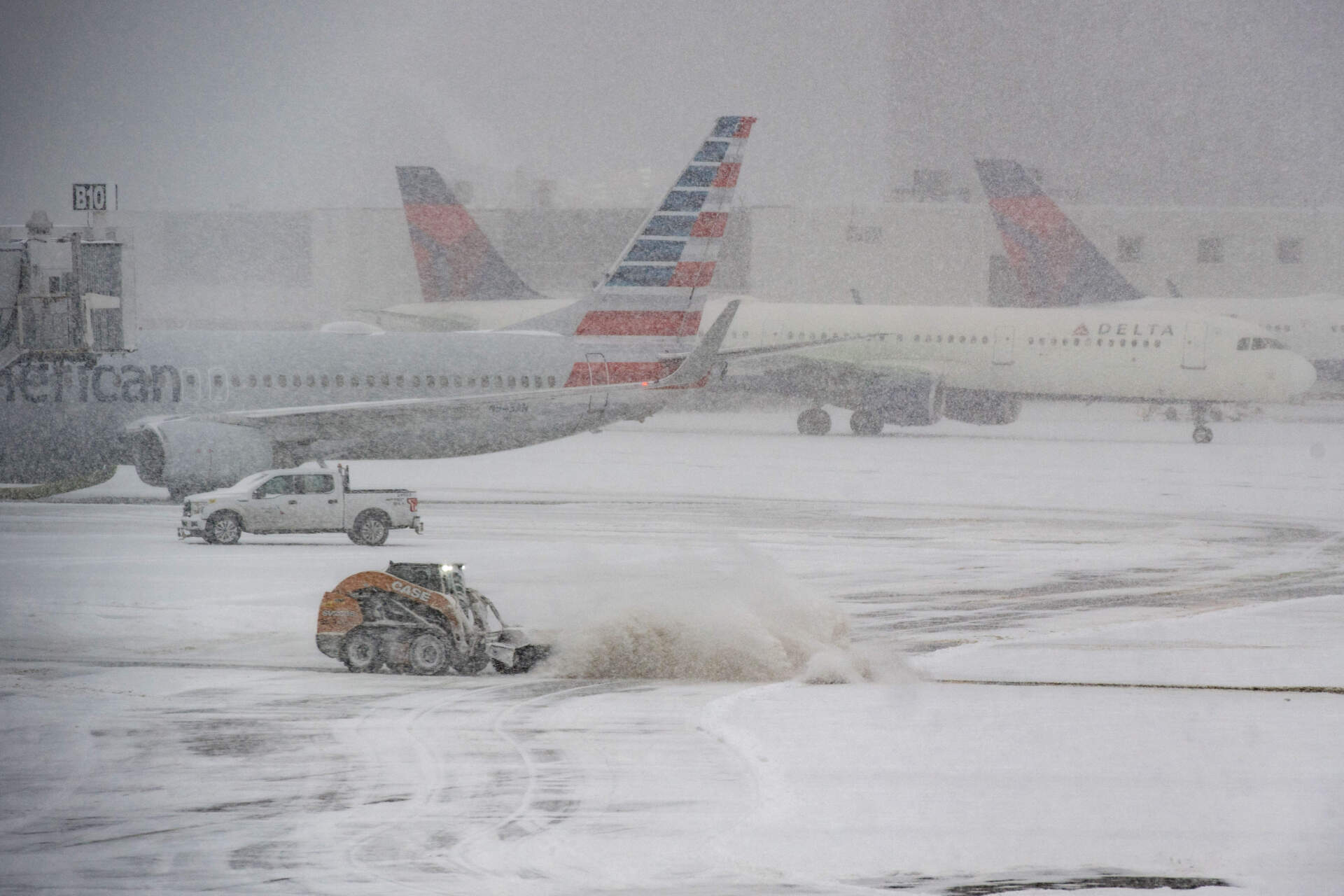 A snow plow works to clear the runways at Logan Airpot in Boston. (Joseph Prezioso/AFP via Getty Images)