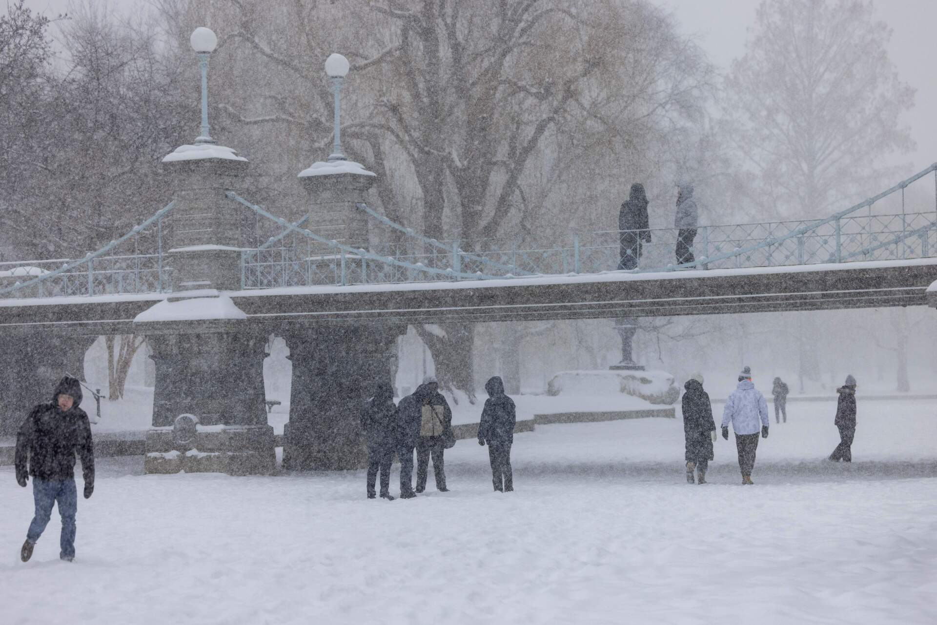 People walk on the frozen Frog Pond in Boston Public Garden during heavy snow on Jan. 25, 2026. (Scott Eisen/Getty Images)